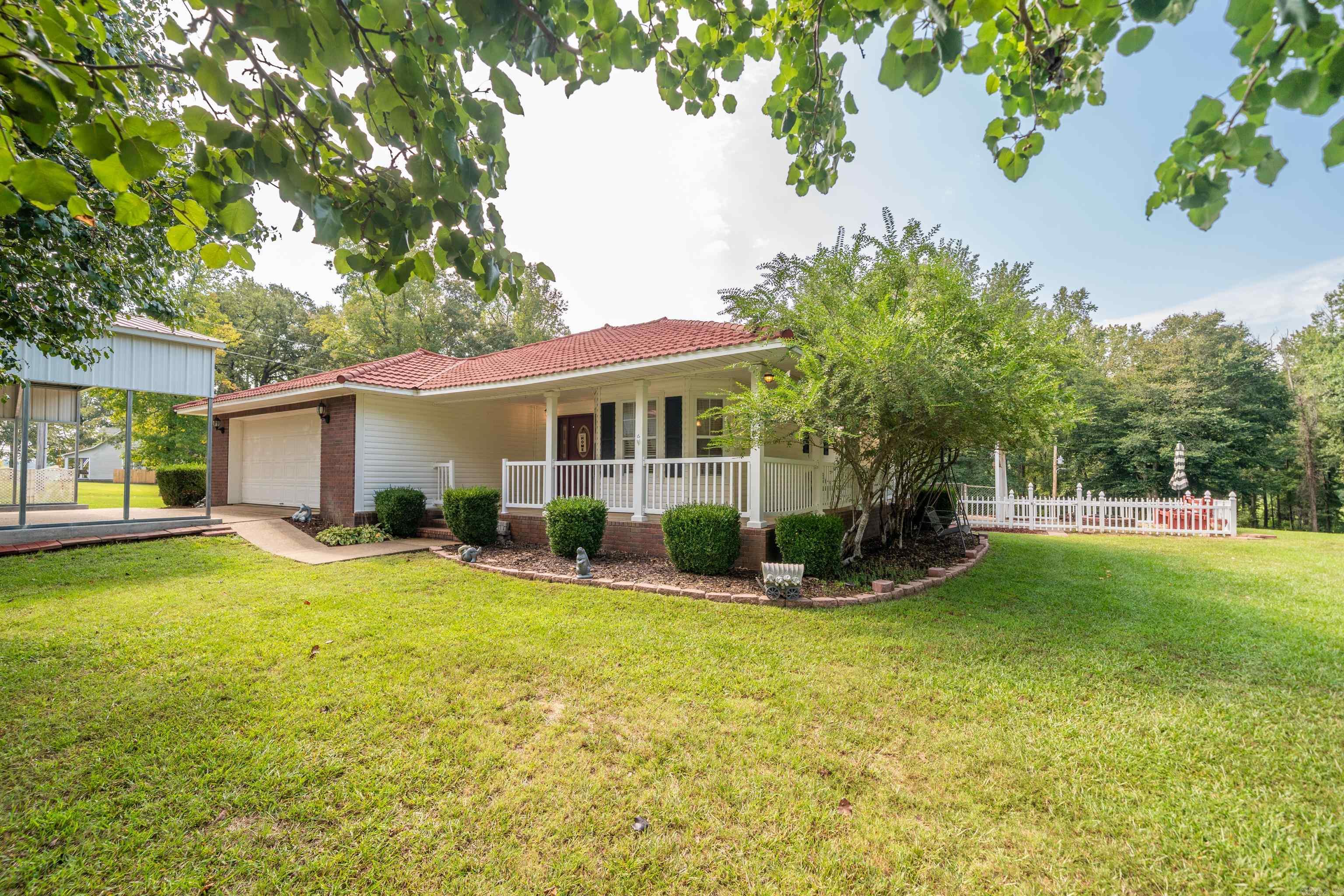 Welcome Home! Recent updates include a new roof and new HVAC system, giving you peace of mind and energy efficiency for years to come. Country living five minutes from shopping, hospitals, and two universities. Fenced in area for pets. Another fenced for hobby horses/farm, landscaped yard, outdoor entertainment area, large pantry, lovely wrap around porch, lots of mature shade trees. Easy access to interstate. Spacious open floor plan. This property has plenty of space to enjoy the outdoors while still being close to city amenities! The property truly shines with a three-bay shop—ideal for hobbies, storage, or home business needs—as well as a charming red shed perfect for gardening tools or extra storage. Over 3.5 acres! Lake DeGray is calling & this is the perfect spot! Schedule your showing today—this one won't last long!