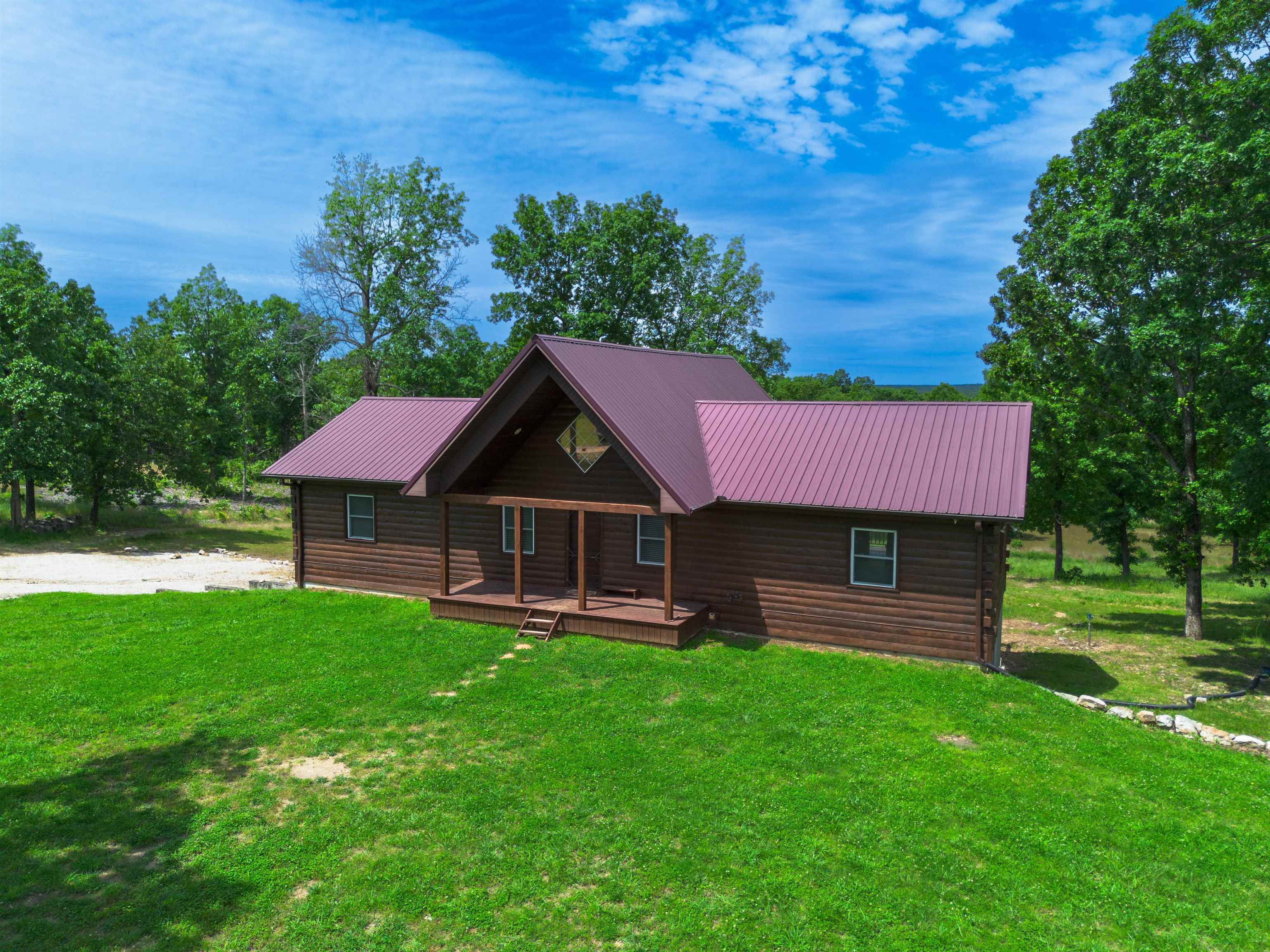 Escape to unparalleled serenity with this exceptional log home, perfectly nestled on 30 private acres of picturesque, mostly wooded land. Blending rustic charm with modern convenience, this property is ideal for those seeking a tranquil retreat and the potential for a self-sufficient lifestyle. Boasting over 2,500 square feet, it features three bedrooms and three bathrooms. The main level offers an open floor plan with hardwood flooring, a vaulted ceiling, and a spacious country kitchen with a wood stove. A unique highlight includes two master suites on the main level, each with a private balcony. The finished basement adds a third bedroom, full bathroom, and a family area, plus a storage area & a storm shelter. This expansive 30-acre property is a nature lover's dream, offering incredible privacy, abundant wildlife, and a spring fed stocked pond. Explore the trails or embrace a homesteading opportunity with ample space for gardening and animals. This move-in ready home includes all kitchen appliances, a washer and dryer, a propane tank, and a whole-house generator, plus a two-car attached garage. Located in the rural area of Salem, AR, this property offers a truly private setting.