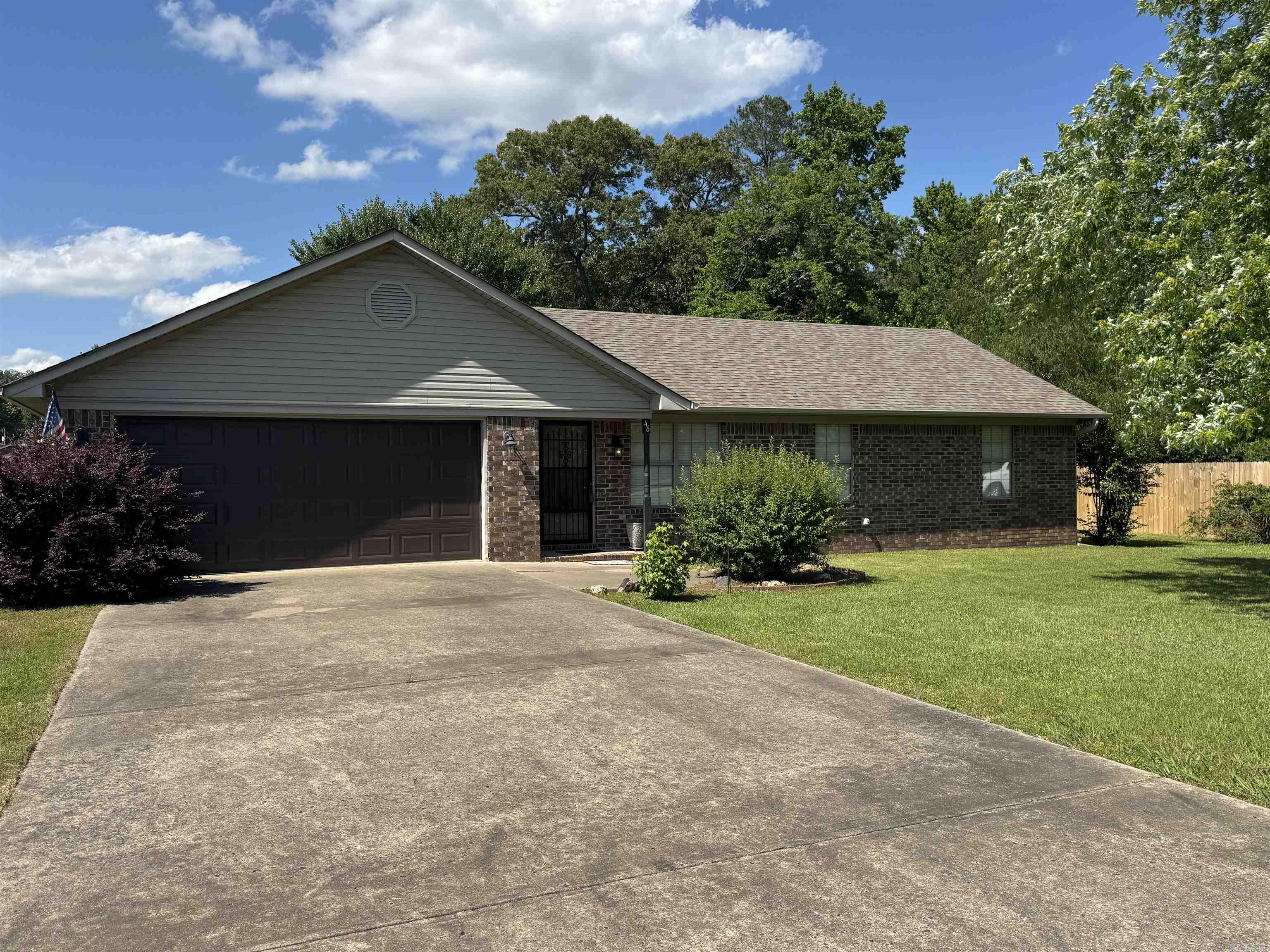 All brick 3 BR, 2 full bath home on large level lot. One bathroom and bedroom is handicap accessible. Kitchen features, stove, dishwasher, microwave, pantry and plenty of storage and workspace. Laundry room has washer and dryer that will convey. Enjoy the lovely backyard from the covered deck. There is also a large workshop, a storage building and a newer tornado shelter. Plenty of place to park a boat or RV in the back with an accessible large gate to drive through. Water heater was replaced in 2024. Home needs some updating but is a well built, well-cared for place families would love. See agent remarks!