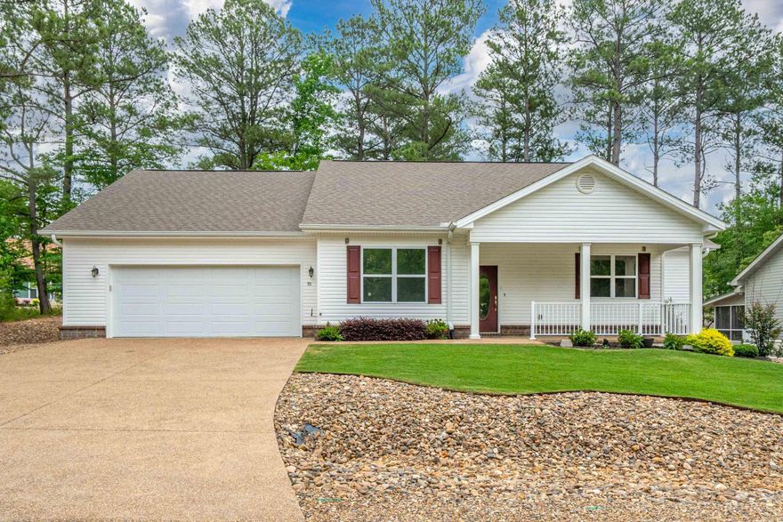 Located in the desirable Maderas Gardens community on the east side of Hot Springs Village, this beautifully maintained patio home offers low-maintenance living in a premier gated golf and lake community. The HOA covers front and back lawn care and landscaping, making this move-in ready home ideal for full-time living or a lock-and-leave lifestyle. This flexible floor plan features 2 bedrooms plus a dedicated office that could easily convert back to a 3-bedroom home. The open-concept layout includes a spacious great room with seamless flow between the kitchen, dining, and living areas—perfect for entertaining. Gorgeous luxury vinyl plank flooring adds modern style and durability throughout.  The oversized primary suite features a spa inspired bath design with dual vanity and toilet areas connected by a shared walk-in shower. Additional upgrades include professionally tinted windows, transferable Leaf Guard warranties, and access to the private Maderas Gardens clubhouse. Conveniently located near golf courses, lakes, trails, and amenities.
