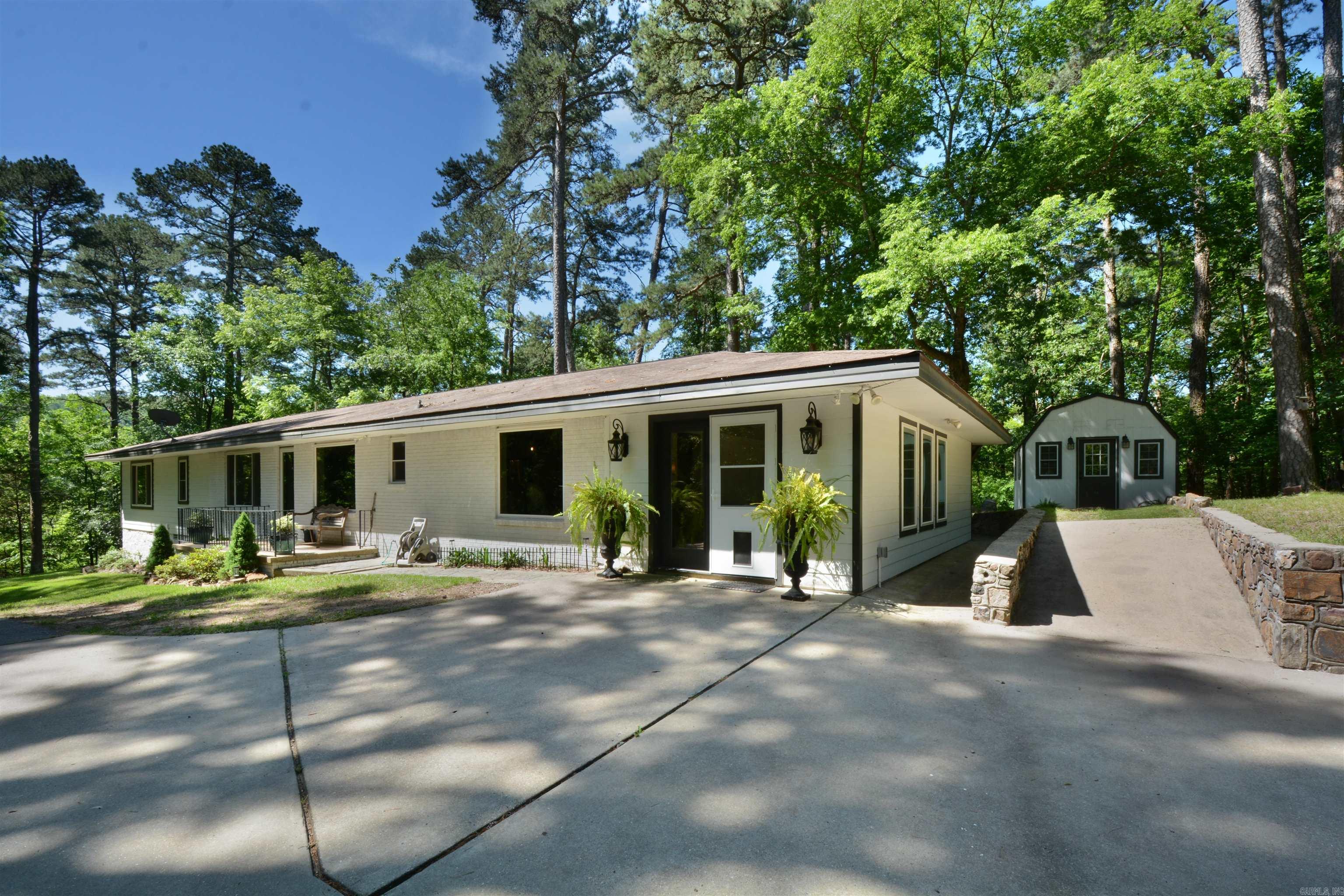 VERY SECLUDED--UPDATED BRICK HOME IN DOWNTOWN HOT SPRINGS, (OFF WHITTINGTON AVE) SITTING ON 1.3 ACRES, GATED, ELEGANT STONE WALL DRIVEWAY- PROPERTY BACKS UP NEAR NATIONAL PARK--JUST MINUTES FROM DOWNTOWN--TOTALLY REMODELED --KITCHEN WITH GRANITE COUNTER TOPS, NEWER CABINETS, LUXURY LAMINATE FLOORING, STAINLESS STEEL APPLIANCES, GOURMET GAS RANGE, OPEN FLOOR PLAN LIVING ROOM RIGHT OFF THE KITCHEN & GAS LOG FP, MAN CAVE/ THEATRE ROOM (12 X 22) COULD BE 5TH BEDROOM, MASTER SUITE WITH TREY CEILING, HICKORY FLOORS, MASTER BATH WITH DOUBLE SINKS, JACUZZI TUB, LARGE TILE SHOWER, COVERED PORCH OFF MASTER SUITE WITH STORM SHELTER UNDER MASTER PORCH (7 X 10) -OFFICE & WORKOUT BUILDING (SEPERATE BUILDING) FROM THE HOUSE COME VIEW THIS EXCEPTIONAL PROPERTY WHICH IS A RARE FIND.