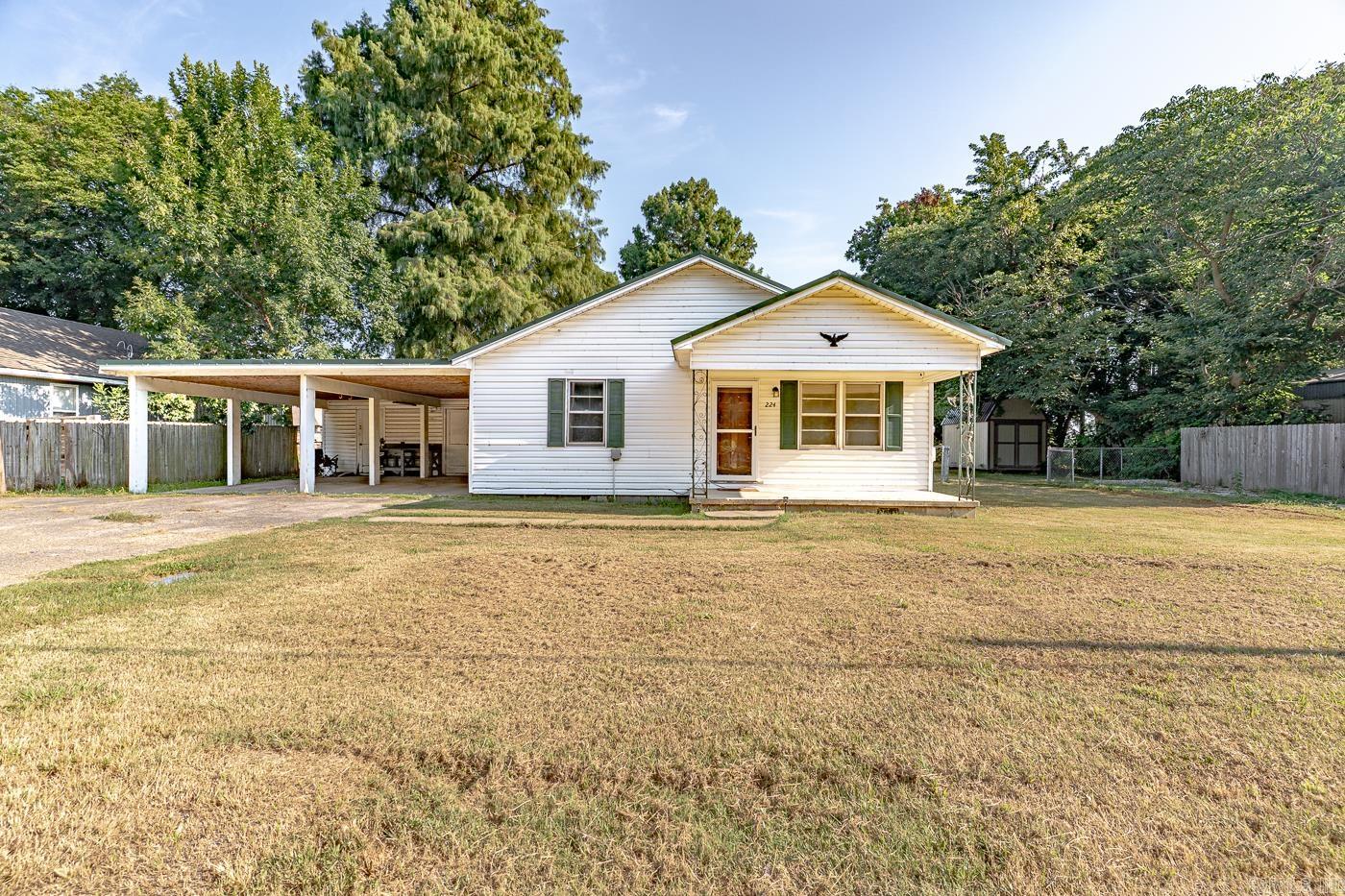 Welcome to Market 224 E Olympia Avenue of the JM Caruthers Addition in Manila Arkansas within the Manila School District. Situated on a level .48 +/- acre fenced and level lot sprinkled w/ shade trees is a well maintained Ranchette Style home wrapped in vinyl, topped w/ a metal roof, and accented by shutters, a covered front porch, attached oversized 2 car carport w/ storage room, expansive driveway ideal for guests, and ornate front door. The interior features 1,343 sf of well laid out living space and contains: a spacious living room w/ large windows, open concept kitchen w/ stainless steel appliances and ample cabinet & countertop space, Master w/ ensuite w/ shower/tub combo, 2 spare bedrooms, spare bathroom w/ shower/tub combo, and laundry room. You'll love the 8 x 16 storage shed purchased in 2024 and the large fenced lot, perfect for pets, play, and gardening. Conveniently located in the heart of Manila close to schools and favorite local retail & dining establishments. Call today to schedule your tour and make this house your home or next addition to your rental portfolio.