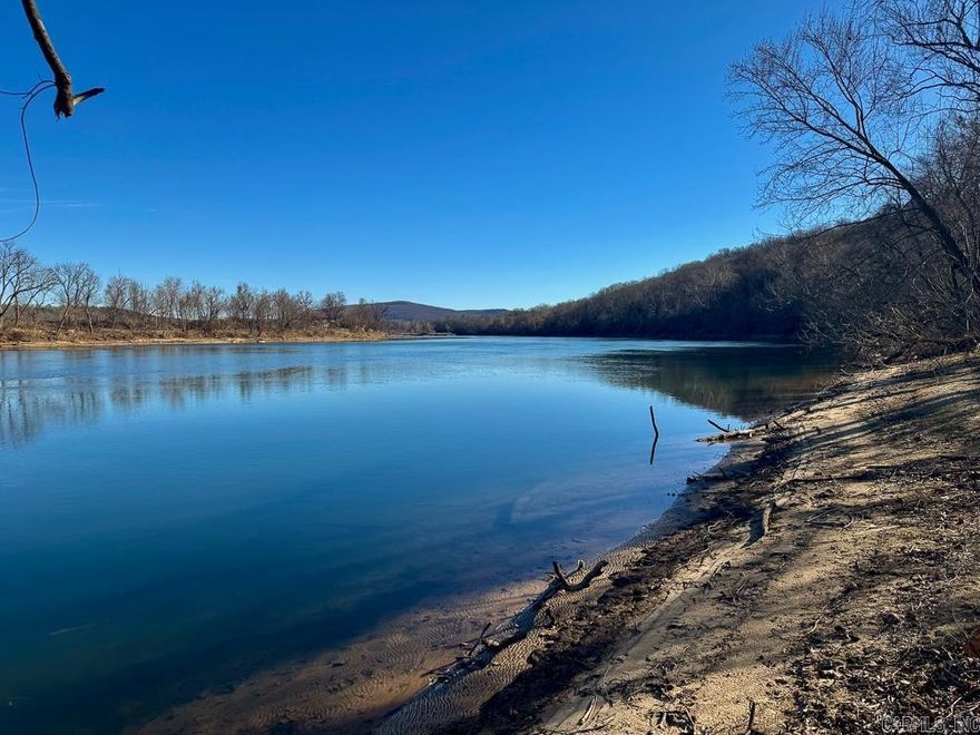 This one-of-a-kind 100 +/- acre tract in Stone County, Arkansas, offers a rare combination of live-water frontage, build-ready improvements, and unmatched natural character. Featuring over 800 feet of frontage on the iconic White River, plus additional frontage along Wallace Creek, this property is truly a river lover’s dream.  At the heart of the property sits a 1,500± square foot barndominium, with approximately 600 square foot of finished living space, ideal for a weekend retreat, hunting lodge, or full-time residence. The structure is already equipped with underground electric and rural water, making it immediately usable while still allowing room for expansion or a future custom home.  The land itself is nothing short of remarkable. Multiple natural springs, towering bluffs, old rock walls, and a well-established trail system create a landscape rich in Ozark history and beauty. A standout feature is the ability to drive a truck or UTV all the way down to the river, offering easy access for fishing, kayaking, swimming, or simply enjoying the water’s edge.  This property balances privacy and accessibility, located just 25 minutes from Mountain View and approximately 30 minutes f