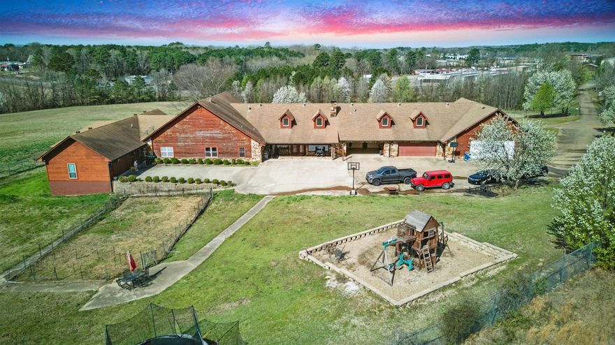 Welcome to your slice of country paradise! This 6,200 sq ft home sits on 17.27 peaceful acres and offers room for the whole family—plus more. With a spring-fed pond, year-round creek, and wide-open spaces, this property is perfect for those looking to enjoy a quiet, rural lifestyle with plenty of elbow room. The home features a warm, functional layout with a large game room that serves as the heart of the house—perfect for entertaining or just relaxing with the family. It separates the main living area from the in-law quarters, offering both privacy and connection under one roof. The in-law suite includes its own entrance, living space, and all the essentials for independent living.  You’ll also find five garages with more than enough space for vehicles, equipment, or your favorite hobbies. Whether you’re into hunting, fishing, gardening, or simply enjoying the land, this property has something for everyone.  With a mix of open pasture and wooded areas, and peaceful water features like the pond and creek, this home offers true country charm and versatility. Come see what makes this place feel like home!