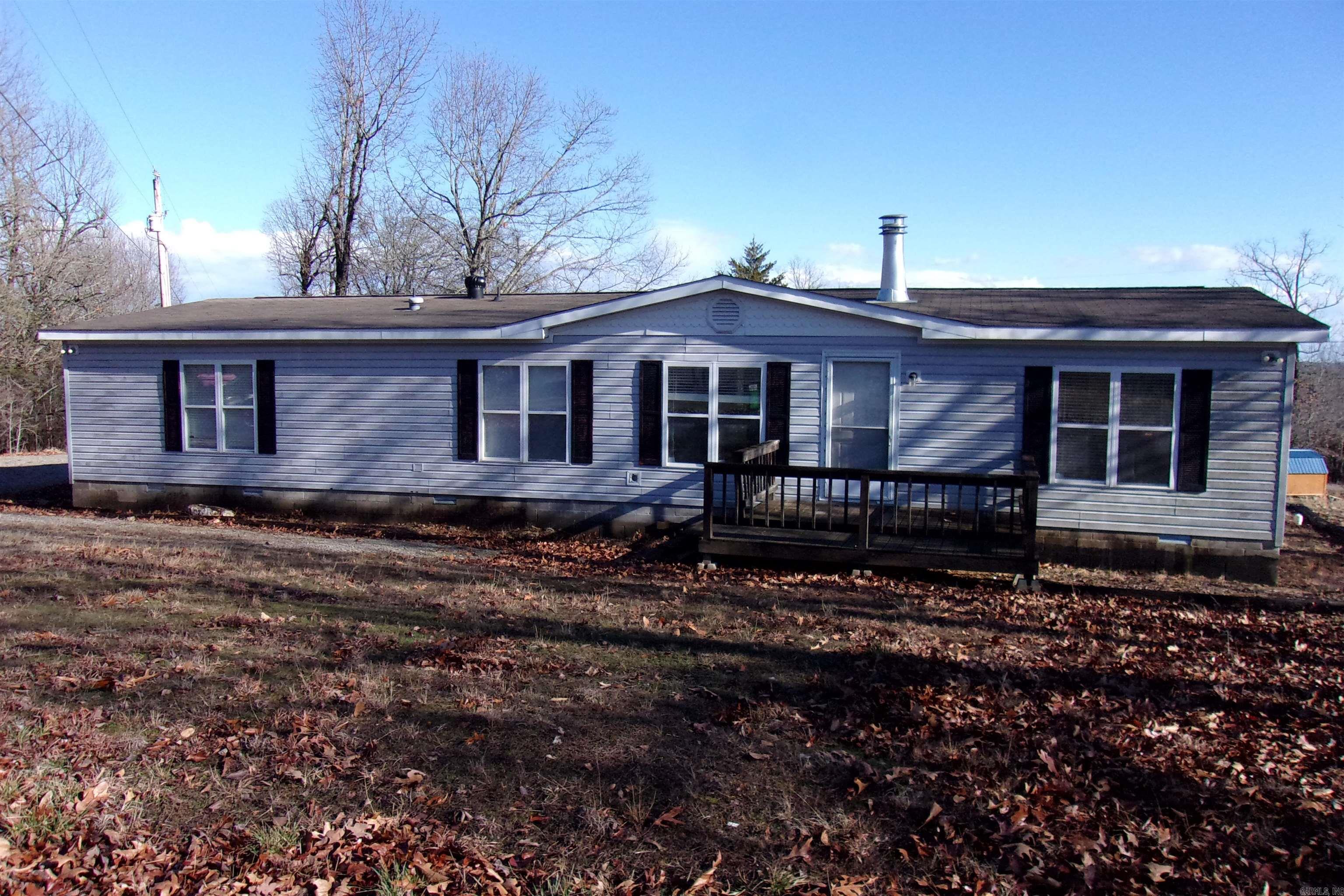 Investor opportunity with tenant in place! Located near scenic Lake Norfork access, this spacious 3-bedroom, 3-bath home offers 1,904 sq ft of comfortable living. Enjoy the inviting living room with a cozy fireplace, an open-concept kitchen perfect for entertaining, and a large primary suite featuring a private en-suite bath. Step out onto the deck to take in beautiful views of nature and local wildlife. Appliances are included for added convenience. With ample indoor space and a peaceful setting, this property is ideal as a rental or vacation home. Owner financing is available. Listed at $215,000.