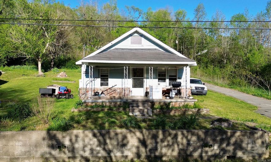 If you are looking for a first home or to downsize, a place to vacation with quick access to all the outdoor fun the Natural State has to offer, or a project place to fix up - this one has all the potential! The springtime brings loads of beautiful blooms across the top of the retaining wall, sitting between the home and the road. There is ample storage in this small home, a large kitchen, and a nice laundry/mud space has been added off the back of the home!   Located just off Highway 9, within walking distance of the baseball fields, the barber, the post office, the park, or the Middle Fork of the Little Red River, this 2 bedroom 1 bath home is being sold with a second city lot that holds a second structure* and a walk-in storm cellar.   *The structure on the second lot is a two bedroom home assumed to have been built in the early 1900s. There is currently no power to the home (although it appears there was at some point) and there is no plumbing in the home. It would require work to make it habitable, but is a solid structure ready for someone to bring into modern-day life!