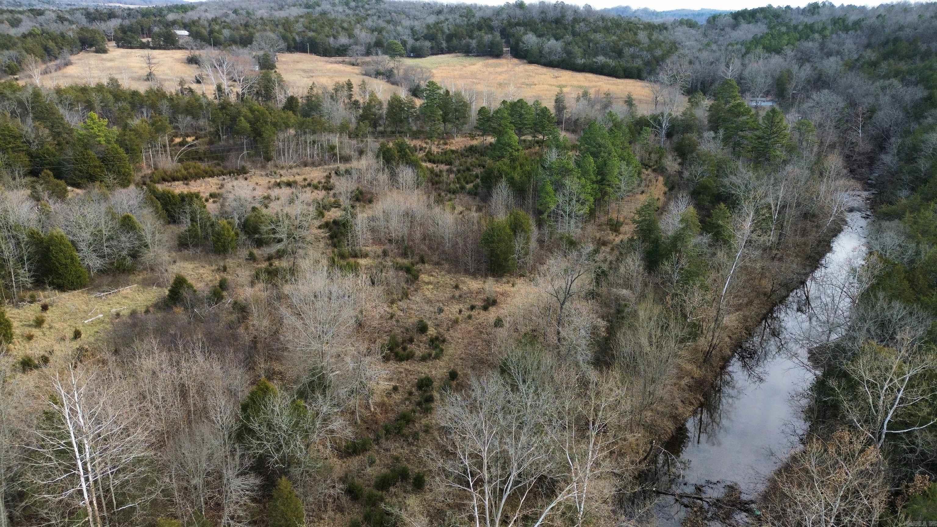 20 Acre Rural Hunting Property With Electricity, Well, And Spring-Fed, Year Round Creek Frontage This secluded 20.33 acre hunting property is what nature enthusiasts have been searching for! You will find joy in the abundance of whitetail deer and turkey roaming the grounds. There are strategically placed deer feeders on the property, offering a prime hunting experience. This acreage also features a half-mile stretch of spring-fed, year-round creek frontage, providing a serene backdrop for your escape into the wilderness. Additionally, there is access to utilities, including electricity and a well from an old homesite on the property. This allows the opportunity to build your private hunting cabin or vacation getaway. Tucked away on a gravel road in rural Melbourne, Arkansas, this property can only be accessed through an easement. Whether you're an avid hunter seeking the perfect spot for game or someone looking to be surrounded by nature, this 20.33 acre property in Arkansas is perfect for you! Don't miss the chance to own this unique property for only $79,900. Contact us to schedule a viewing or get more information.
