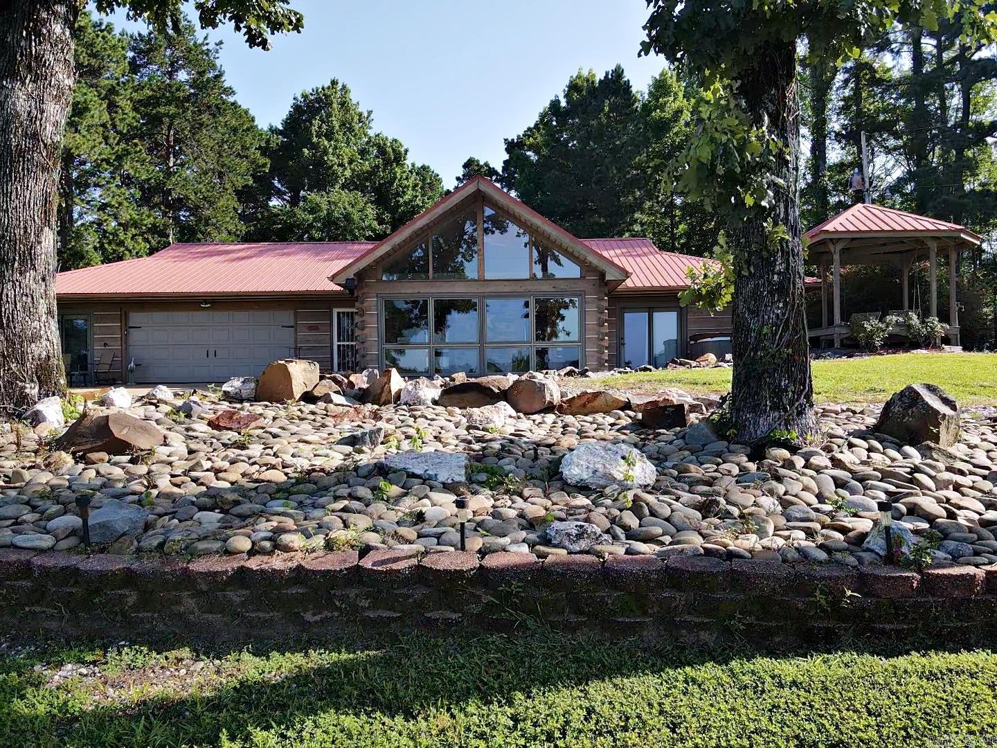 ONE OF A KIND property sitting on an inviting 1.20 acres near the desirable Degray Lake State Park Golf Course. 1 Bedroom, 2 Full Baths, 1189 sq ft. Rock FP w/wood burning insert gives you a bungalow/cottage feel. Enjoy the tiled sunroom with beautiful views of the golf course, or have a front row seat in the gazebo swing or hot tub. Kitchen has granite and lots of cabinet storage with pull-outs. Spacious garage to keep your belongings tidy, PLUS, room for a second BR, mancave, bunkhouse or office. Private back yard with plenty of room to spread out, entertain, or enjoy the firepit. Keep your landscaping looking luscious and your water bill low with a separate well to water the exterior. If you like to view wildlife- the deer in the back will keep you busy trying to catch a peek at them. Call today, this is a must see!