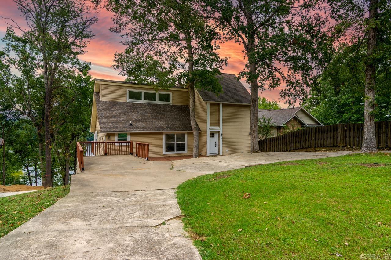 Lakefront Retreat in Diamondhead – Dock Potential & Golf Access Welcome to your lakeside sanctuary on Lake Catherine! Nestled within the secure gates of Diamondhead Golf Community, this remodeled 4BR/2.5BA tri-level home combines comfort and elegance with stunning water views and over 600 sq ft of outdoor deck space, all situated in a secluded cove. Highlights: Lakefront lot with approved boat dock permit (plans included) Excellent bass fishing right off the swim dock New kitchen with custom cabinetry and granite counters Spacious living areas with floor-to-ceiling windows showcasing lake views Finished basement with private entry—ideal for guests or a home office Access to golf, swimming pool, clubhouse, and tennis Affordable HOA at $1,300/year covering amenities and security Short-term rentals permitted—ask about income potential! Perfect for a second home, investment, or retirement—this property offers a rare blend of lakefront living and resort-style amenities, just minutes from Hot Springs. Call for a private showing or virtual tour today!