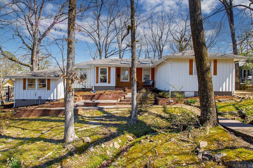 Discover this stunning mid-century modern home, offering 3 bedrooms and 3 bathrooms, including dual primary suites for ultimate flexibility and comfort. Remodeled in 2022, this home seamlessly blends modern upgrades with timeless design.  The open-concept layout creates an inviting atmosphere, perfect for entertaining, while the Pottery Shed-inspired aesthetic adds charm and character. Enjoy the warmth of oak plank floors throughout, complemented by quartz and granite countertops in the beautifully updated kitchen. Primary bath has heated floors, perfect for those cold mornings. A gas range makes cooking a delight, and the new HVAC system ensures year-round comfort.  Nestled on a serene lot with a wooded front yard, this home offers privacy and natural beauty, all while being conveniently located in the heart of Little Rock. Whether you're hosting guests or enjoying a quiet evening at home, this stylish and functional space is designed to impress.