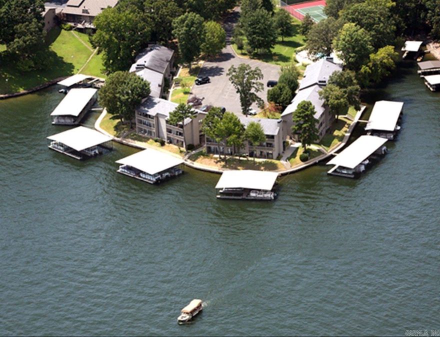 2 bed, 2 bath updated condo on Lake Hamilton with great views and direct lake access. Enjoy the private balcony, covered boat slip, and easy access to the water. Inside, you’ll find natural light throughout, stainless appliances, updated countertops, and a spacious master suite with attached bath.  The gated community includes a pool, tennis courts, and is close to dining, shopping, and entertainment.  No nightly rentals allowed. Furnishings included with an acceptable offer. Boat lift negotiable.  Agents: Use Showing Service to schedule showings.