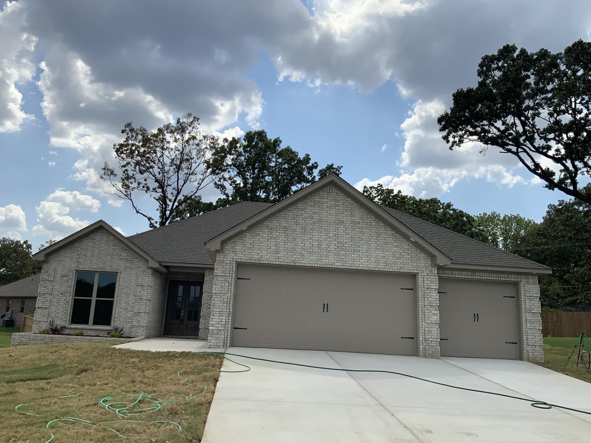 New Construction: Beautiful open floor plan features 4 bedrooms, 2.5 baths with luxury vinyl flooring throughout. Kitchen features an abundance of white painted cabinets and stainless- steel appliances, large island with a nice large walk-in-pantry. Nice large laundry room with a sink and extra cabinets and room for a second refrigerator. Split bedroom plan. Spacious master suite with a separate walk-in shower, double sinks and a very nice (extra- large) closet with built-ins. Concrete covered deck with a ceiling fan. Three car garage with storage and a walk up stairway to attic. Tankless hot water heater. SF approx. measuring encouraged.