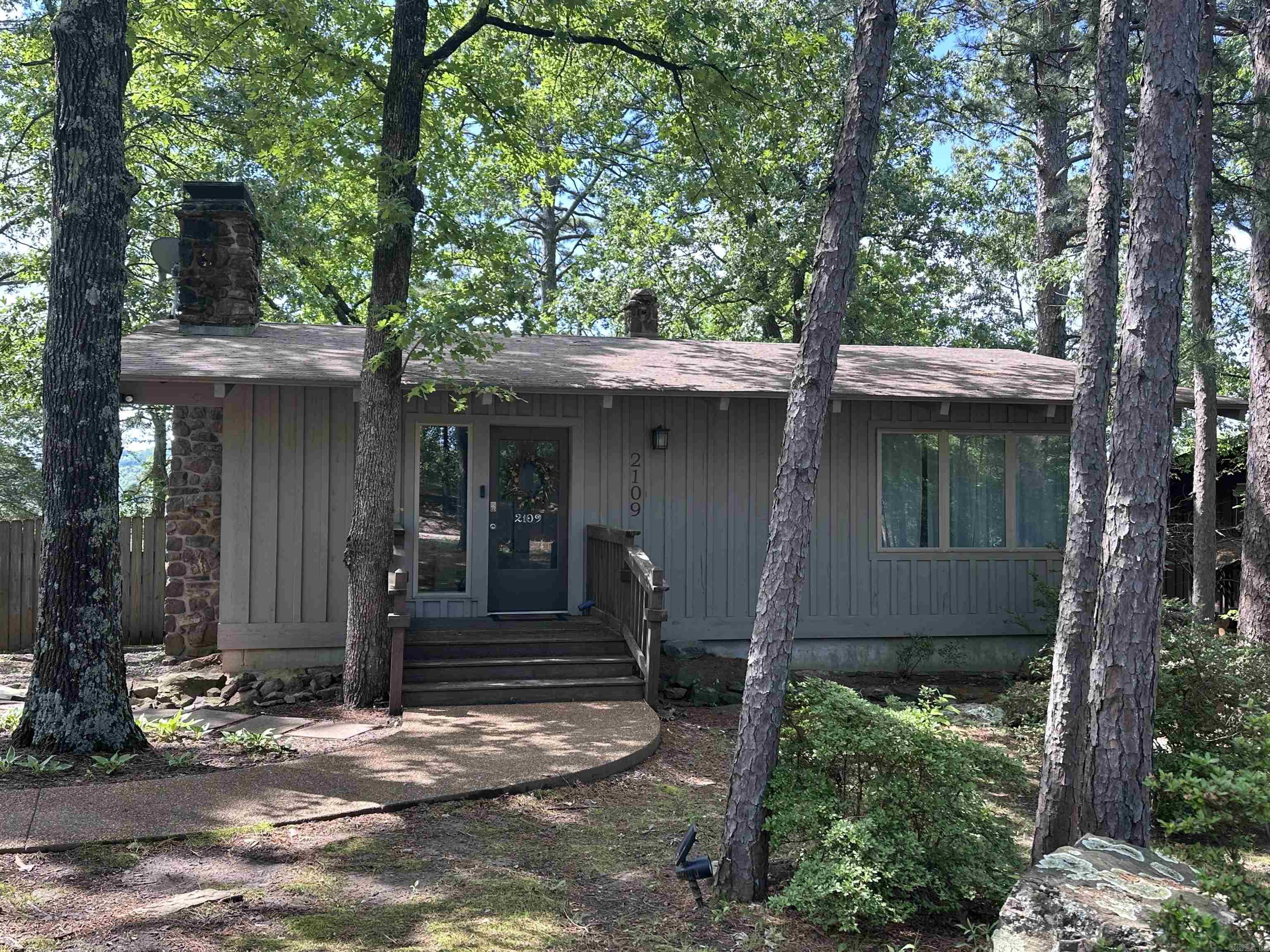 Nestled beneath a canopy of mature shade trees with an added corner lot, this inviting 2-bedroom, 2-bath home offers the perfect blend of comfort, character, and opportunity. Featuring a classic rock fireplace, a functional kitchen, and cozy living spaces, this property exudes rustic charm and potential. Located just across the street from the lake and scenic trails, it’s ideal for outdoor enthusiasts and nature lovers. Whether you're looking for a relaxing retreat, a vacation rental investment (VRBO potential), or even a commercial venture—the property’s original use—this versatile home fits the bill. Just minutes from downtown Heber Springs, you’ll enjoy quick access to shops, dining, and local attractions while still enjoying the peaceful, wooded setting. Beautiful lake view in fall/winter and within minutes from a boat launch located just around the corner. Don’t miss your chance to own this unique gem with endless possibilities!