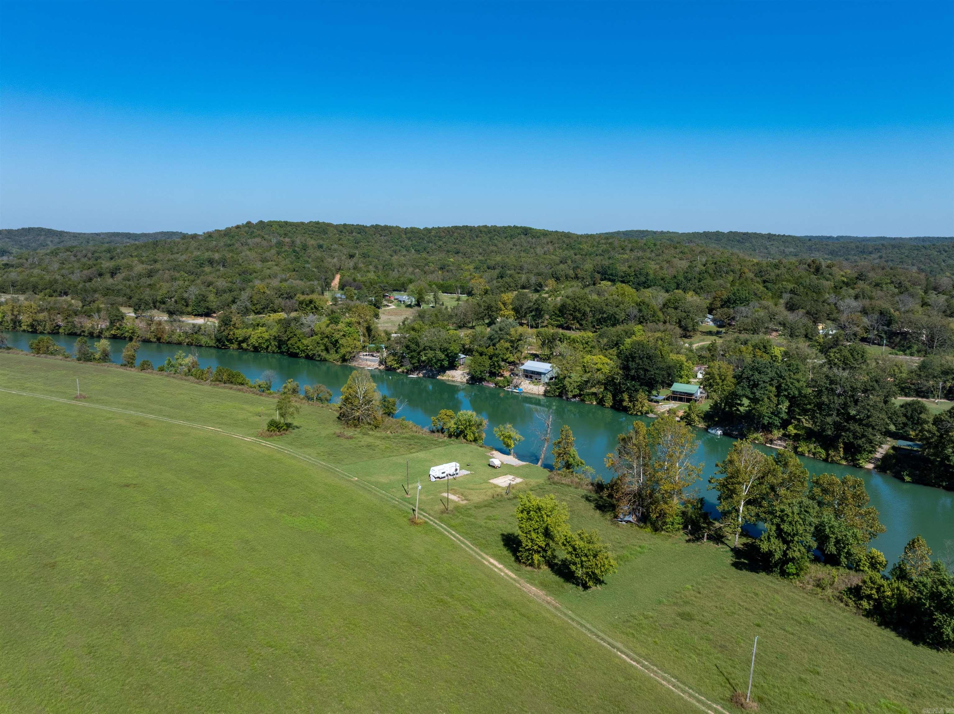 Looking for a spot on the Spring River near Hardy, Arkansas? This property is minutes from downtown and already set up with a concrete slab and electric on siteābring the camper now or design a cozy river retreat for weekends in the Ozarks. Easy river access for floating, fishing, and relaxing by the water. Level area near the water with space for outdoor seating, fire pit, and gear storage makes this an ideal, low-maintenance base for year-round recreation. Highlights: ⢠Spring River location near Hardy ⢠Concrete pad in placeāRV/camper ready ⢠Electric on property ⢠Easy access to the river ⢠Great setting for a small cabin or vacation spot ⢠Close to shopping, dining, outfitters, and river fun