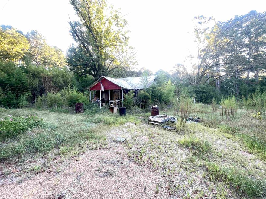 Beautiful piece of country land! Nestled in Locust Bayou, this 26 acre parcel offers a current residence that needs restorative work (sold as-is), as well as a mobile home site to the right of the main house (conveyed at no value).  The owners have enjoyed hunting a variety of game in the wooded portion, the majority of the acreage.  A small pond is situated within the tree line.