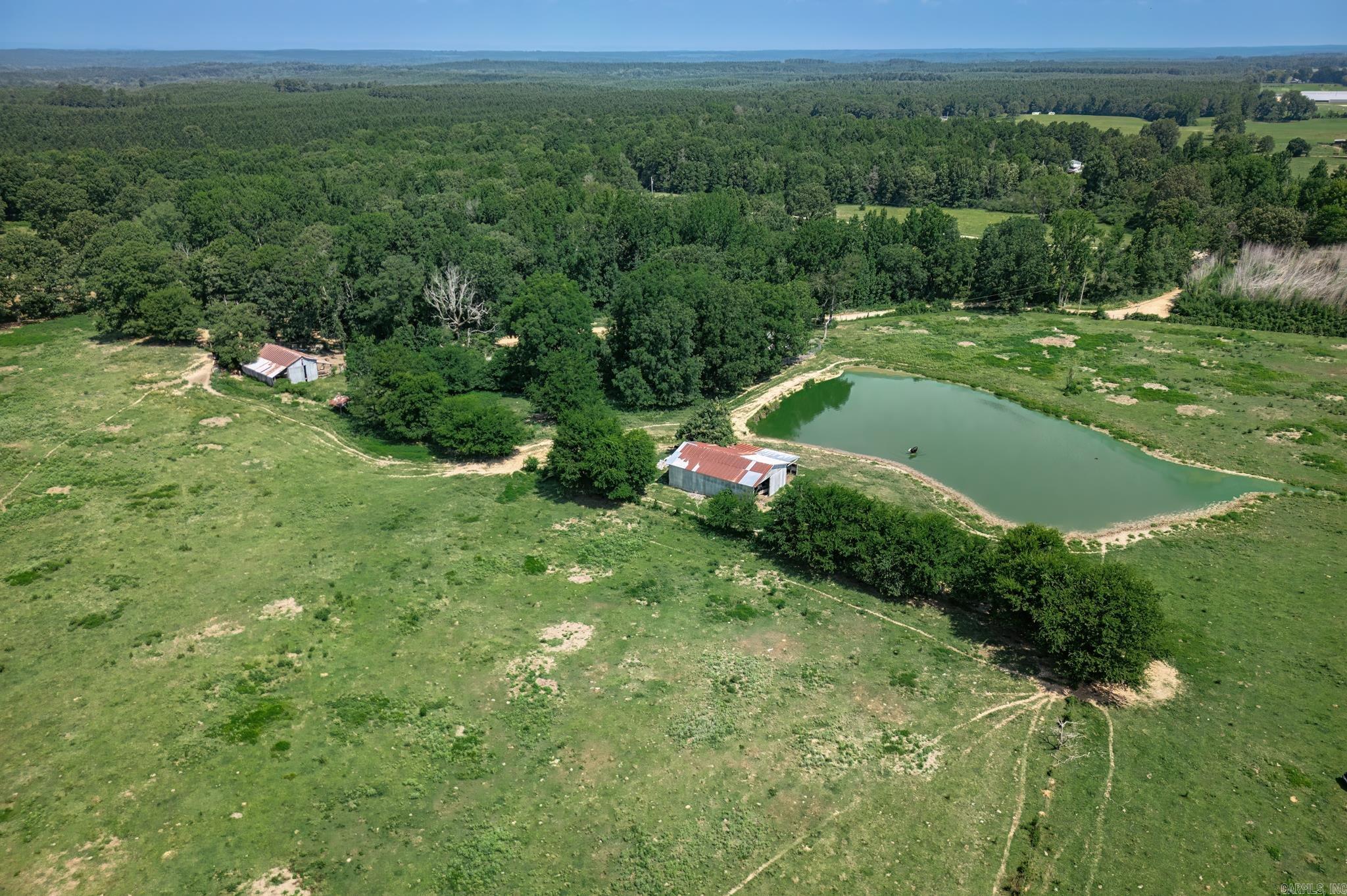 Welcome to your dream property! This 3-bedroom, 2-bath home is nestled on 63 acres of lush pastureland, making it ideal for those looking to run cattle or enjoy vast open spaces. The property boasts two pondsāa large one and a smaller oneāperfect for livestock or recreational use. Multiple outbuildings, including barns, provide ample storage and operational space for your agricultural needs. While the home requires some TLC and updates, it is structurally sound and features a basement that can be easily finished to add more living space. With road access from both the front and the back, this property offers convenience and versatility. This is a perfect opportunity for someone seeking a serene, rural lifestyle with plenty of potential for customization and growth.