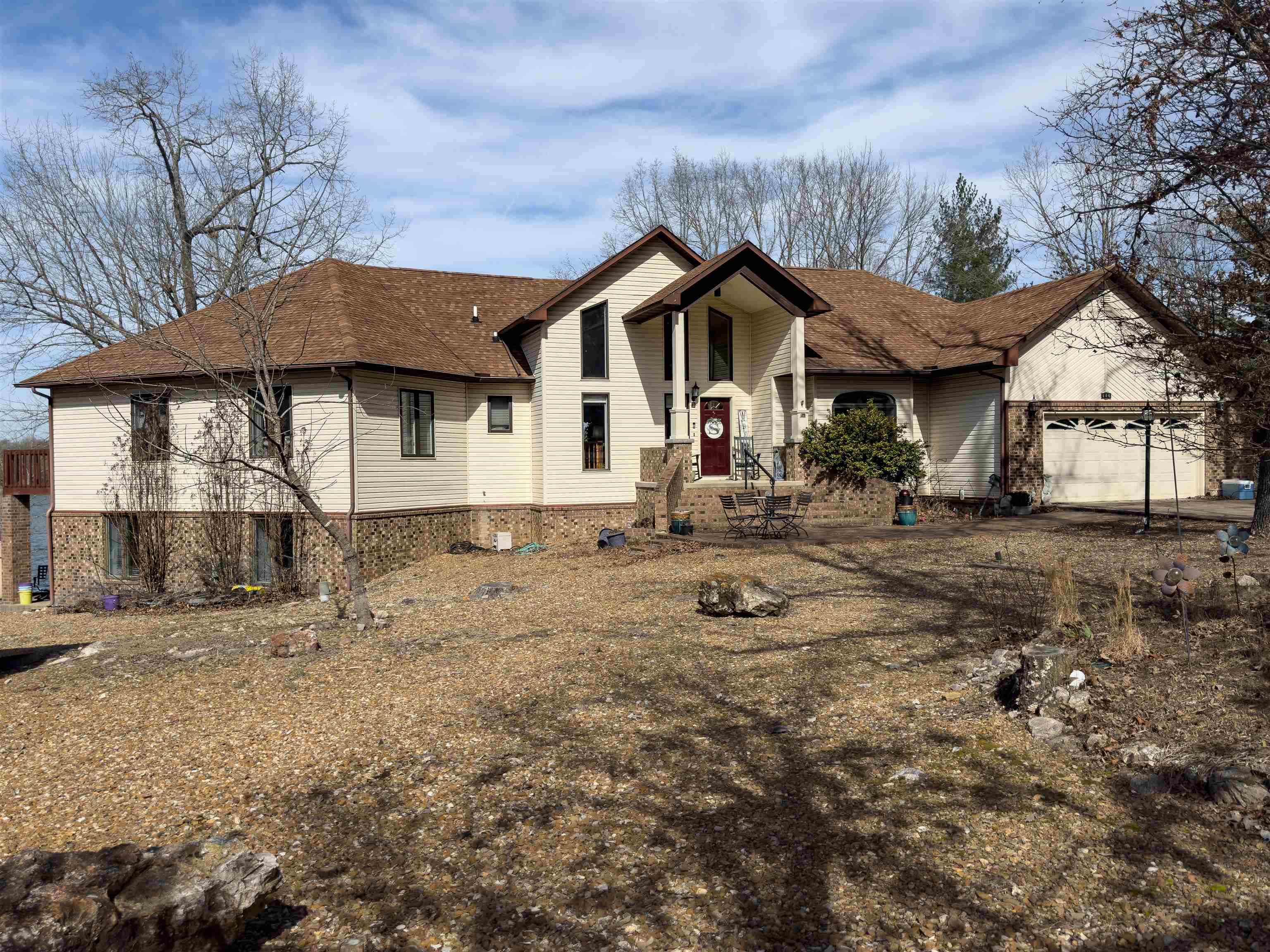 Spacious Custom Lakefront Home...On two of the best Crown Lake lots to be found. From the office to 5 Bdrms, multiple living areas, formal dining plus breakfast bar, two eat-in kitchens, porches, decks, patio, private dock & boat launch, RV hookup, garage, extra storage, fabulous sunsets and parking galore, you can live the dream. Beautiful tile, hardwood, granite, vaults, cabinets, laundry areas, sitting & bonus rooms. Minutes to dining, groceries, marina & health care.