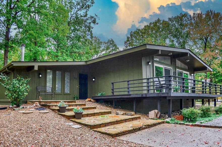 Welcome to this beautifully updated 2 bedroom, 2 bath home nestled in a quiet neighborhood in Hot Springs Village, AR. Fresh paint inside and out gives the home a crisp, modern feel, while vaulted beam ceilings and large windows create a bright, airy living space filled with natural light. The spacious living room flows seamlessly into the dining area and kitchen, making it perfect for everyday living and entertaining. A versatile bonus room offers endless possibilities—ideal for a home office, hobby space, or guest overflow. Step outside to enjoy the peaceful backyard patio, surrounded by mature trees and tasteful landscaping that provide privacy and a serene setting. Whether you’re sipping your morning coffee or hosting friends, this outdoor space is sure to impress. Located in the heart of Hot Springs Village, you’ll enjoy access to all the amenities this vibrant community has to offer, including lakes, golf, walking trails, and more. Move-in ready and thoughtfully updated, this charming home is the perfect blend of comfort, style, and tranquility.