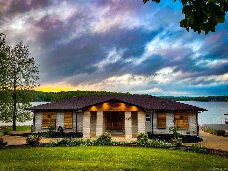 Exclusive lakeside sanctuary! Unparalleled estate features 3 ensuite bedrooms. Be pampered with the primary suites' spa-like soaking tub and panoramic views. Launch your boat effortlessly from your private ramp. The pièce de résistance? A real moat with cascading waterfalls, creating a truly enchanting atmosphere..It's a feature unlike any other, making this home truly unique. Indulge your culinary passions in the climate-controlled indoor/outdoor kitchen.Entertain guest as you dine al fresco, surrounded by soothing lake sounds. Unwind in the hot tub to witness the breathtaking sunsets. The drive-thru garage has electric charging station with plenty of storage. This retreat offers ultimate in luxury living designed for your enjoyment. Furnishings convey with acceptable offer