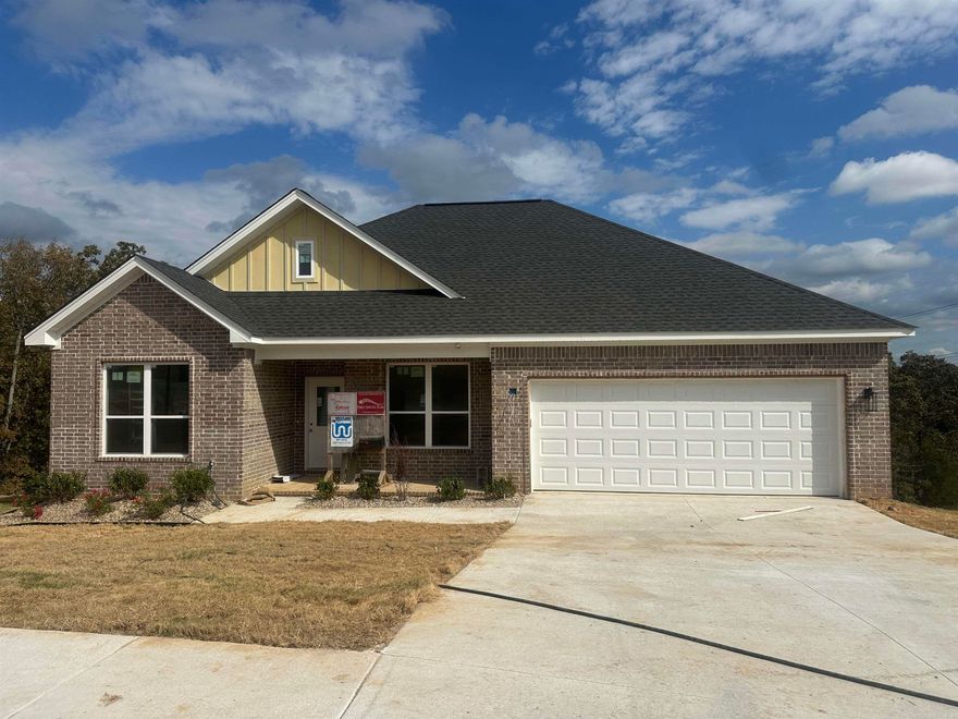Home built by G2 Contractors.  Many upgrades to include all brick exterior, foam insulation, gutters, and huge yard overlooking the hillside for privacy!  Three bedrooms and 2 1/2 baths, which is so convenient for guests!  Love the center island with space for six bar stools!  Soft painted trim and cabinetry for soothing relaxation!  Cool electric fireplace that has changing fire colors. Stainless steel appliances and luxury vinyl flooring throughout makes this an easy care home!  The custom tiled walk in shower will be your favorite place in the primary bathroom! Nice deck to watch the deer play! Completion date to be November 2025.