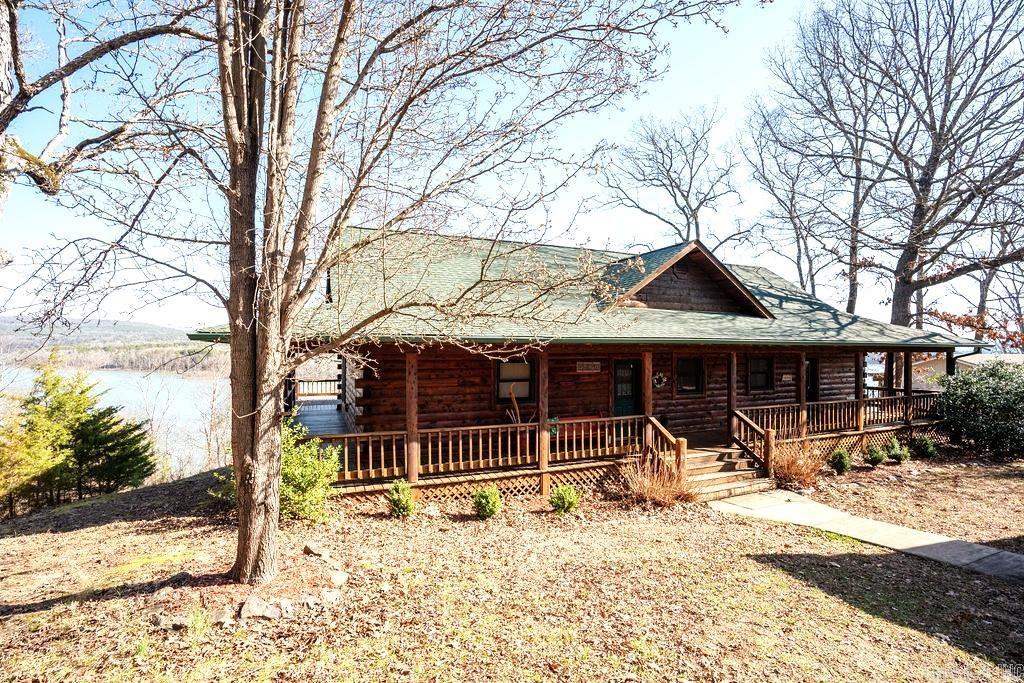 LAKEFRONT! Custom built in 2005, this beautiful log home is your dream lakeside retreat. Enjoy the gourmet kitchen with premium appliances, Corian counters, abundant storage; all while taking in the views of Greers Ferry Lake and Ozark Mountain foothills. The porch, deck wraps aroun the home for your relaxing pleasure watching wildlife and the lake. The back yark has a firepit and hot tub. The lower level features a second living area and second gas log fireplace. Two bedrooms and one bath downstairs; the large extra room/game room could serve as a 4th bedroom. The detached garage has extra storage/work area; home and garage roofs renewed in 2024. Across the street there is the additional garage/shop for storage of boats and lake toys plus a fenced garden area and a large greenhouse. All this is just .9 miles from Choctaw Marina ( a 20 minute walk). Come see this fantastic home soon!