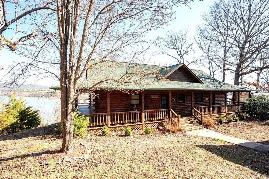 LAKEFRONT! Custom built in 2005, this beautiful log home is your dream lakeside retreat. Enjoy the gourmet kitchen with premium appliances, Corian counters, abundant storage; all while taking in the views of Greers Ferry Lake and Ozark Mountain foothills. The porch, deck wraps aroun the home for your relaxing pleasure watching wildlife and the lake. The back yark has a firepit and hot tub. The lower level features a second living area and second gas log fireplace. Two bedrooms and one bath downstairs; the large extra room/game room could serve as a 4th bedroom. The detached garage has extra storage/work area; home and garage roofs renewed in 2024. Across the street there is the additional garage/shop for storage of boats and lake toys plus a fenced garden area and a large greenhouse. All this is just .9 miles from Choctaw Marina ( a 20 minute walk). Come see this fantastic home soon!