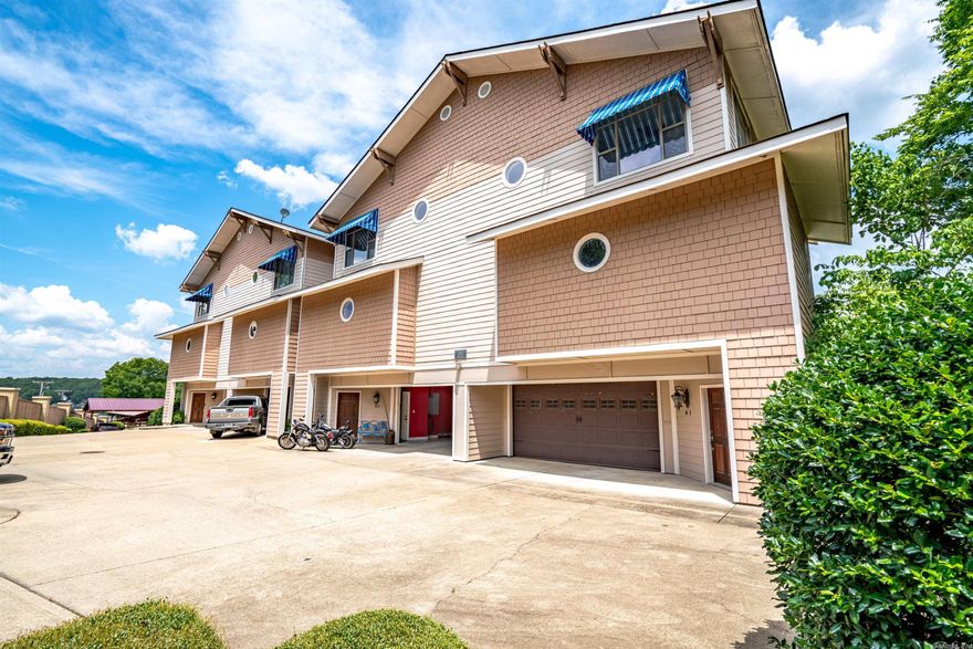 Talk about a lake condo on Lake Hamilton!  In the gated subdivision of Bel Lago that has a 2-car oversized GARAGE and a community pool.... this SUPER CLEAN, NEVER BEEN LIVED IN condo has approx. 2426 sq. ft. 2DR and 2.5 Baths.  Open Kitchen with custom cabinetry, lots of built-ins, granite countertops, double sink, trash compactor, breakfast bar and table area....Open floor plan, double crown molding with wood and carpet floors.  Large (9'x27') storage room in back of garage is a real bonus!
