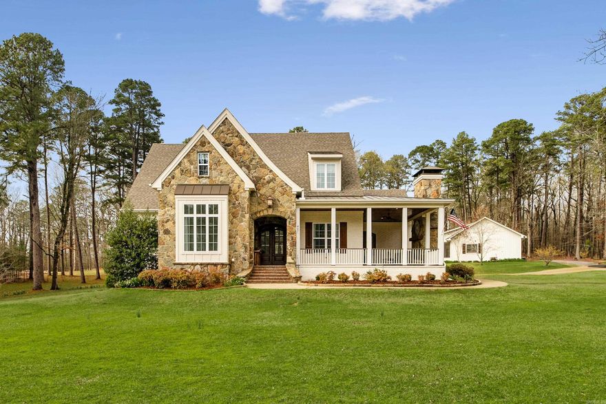 STUNNING PRIVATE ESTATE WITH GUEST HOUSE ON 3.85 ACRES! A stunning foyer opens to a spacious living room with gas fireplace and wall of French doors. The  chef’s kitchen features a 6-burner gas range, double ovens, large island, and oversized Butlers pantry with desk, flowing into the formal dining area with pass-through wet bar and beverage cooler. The primary suite on the main level includes two walk-in closets, double vanities, custom tile shower, and freestanding tub. An additional bedroom also on main level that would make a great office. Upstairs offers two bedrooms with ensuite baths, a large bonus room, and 720 sq ft of unfinished space already wired and plumbed for a potential 5th bedroom. Enjoy the wraparound covered porch with stone fireplace, screened back porch, and park-like backyard with raised garden beds. Property also includes a 800 sq ft guest house with commercial kitchen, bedroom, and bath, a huge heated and cooled workshop with massive storage, an additional two-car shop/garage. Hot tub and whole-home generator to convey! (tractor negotiable)