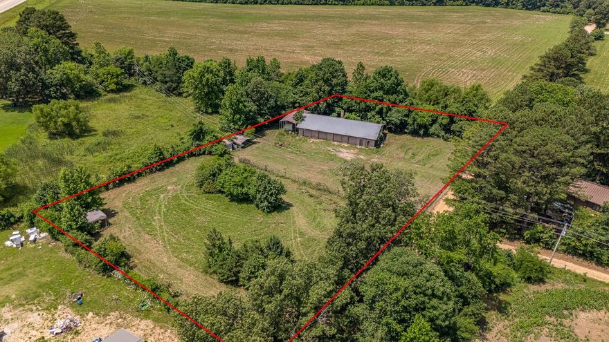 Former auto shop with 4 bay doors, metal roof and concrete block building for sale, fenced property, approx 1.86 acres of land across from home for sale, as is sale, estate sale