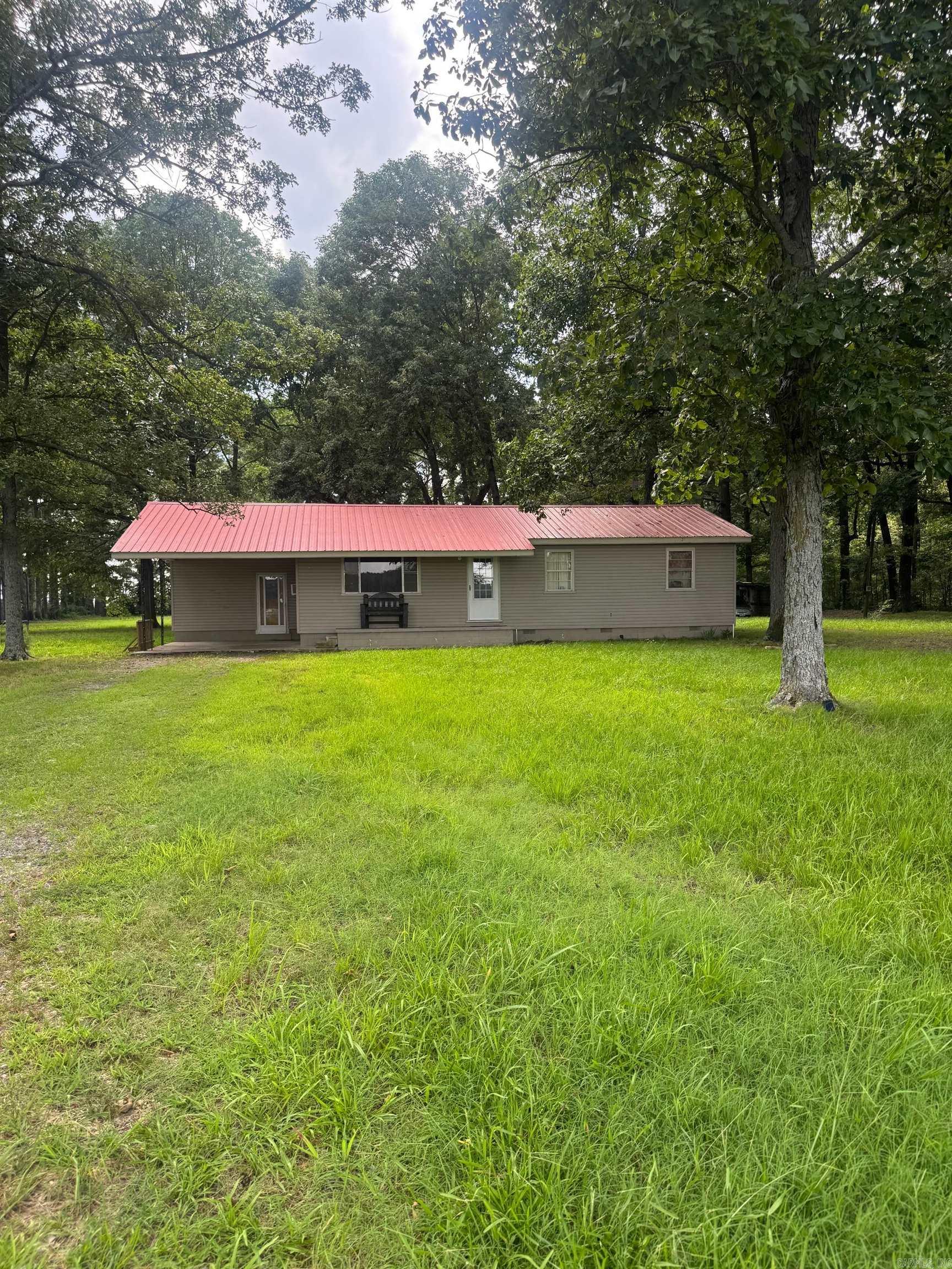 Escape to +/- 0.75 serene acres of countryside, where this cozy retreat offers a private haven for outdoor enthusiasts and hunters alike. Sellers have recently added a new deck on the back and done the roof repairs! Tucked away from the city, this property is ideal for those who value seclusion, natural beauty, and room to roam. Step into this welcoming home, featuring practical living spaces and a functional kitchen. Outside, the land shines with open space, multiple outbuildings, and a storm shelter, offering ample storage for hunting gear, decoys, and outdoor equipment. Brand New Deck on the back! Picture yourself sipping coffee on the porch as the sun rises or gearing up for a successful day in the duck blind. The backyard is perfect for family moments, whether the kids are playing in the wide-open spaces or you’re swapping stories by a fire. Despite its tranquil setting, this property keeps you close to essentials, just 15-20 minutes from town. It’s the perfect mix of peaceful retreat and convenient access. Square footage approximate, please measure.