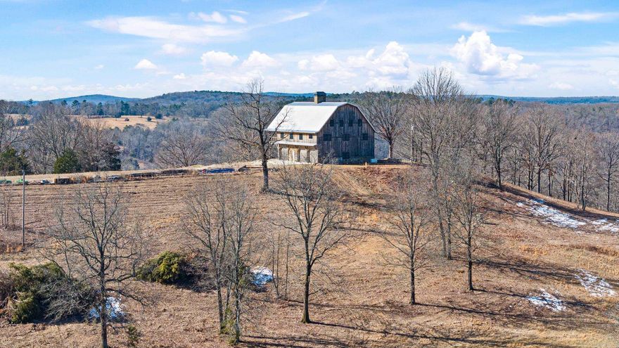 This is a once in a lifetime opportunity! The Snowlick Mountain Ranch includes 317.78 Acres and Panoramic views for miles. With roughly 100 Acres of manicured fields, 4 ponds and the remaining prime hunting ground with napier creek running along the southern border. This tract was previously a high fence ranch with miles of 8 foot fence still remaining. The Brand New Custom built (Timber Frame) Cabin is like something you'll only see from a magazine. Every Log, board and Peg that built this Cabin was harvested from this property, it's so incredible to see the craftsmanship and perfection that went into this build. The Cabin is 5,600 Sqft Heated and Cooled with the garage area included. Upstairs in the main living area is 2,800 Sqft 2 Bedrooms and 3 Full bathrooms. THIS WILL NOT LAST LONG!