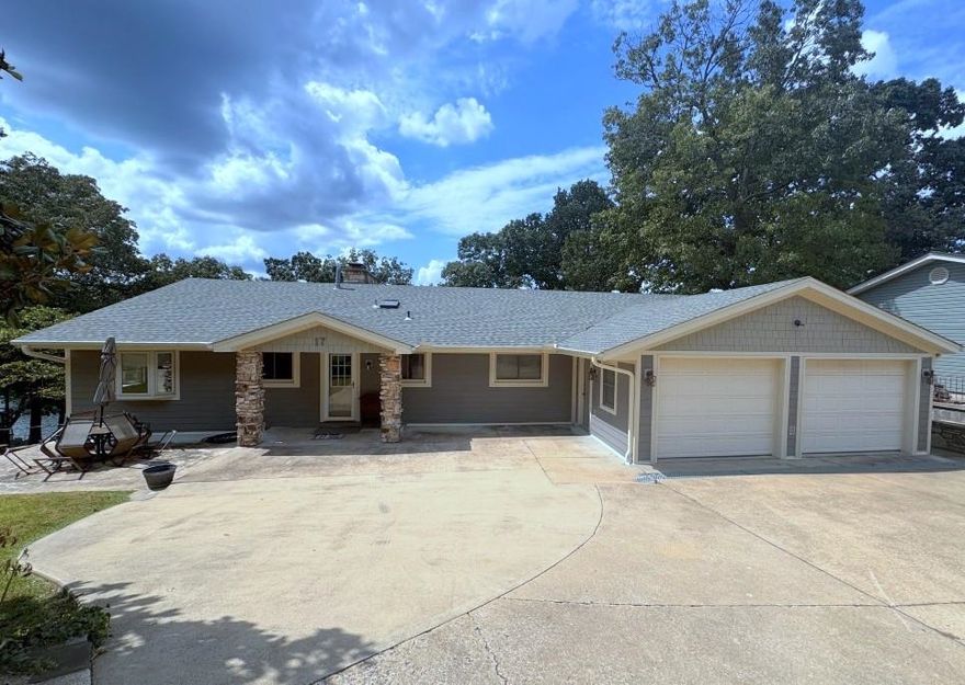 This Lake Thunderbird home, replete with a dock & concrete boat house in good water, locates on a quiet cove. Its shore line is perfect for swimming, fishing, & playing on the beach. The two-level home is designed for easy living-bedrooms & bathrooms on both levels, a large family room-complete with both a pool & ping pong tables-is on the lower level. The large primary bedroom suite is also on the lower level with a view of the lake &has a wood burning insert.  The large laundry comes with washer and dryer installed and utility sink.  The main floor has 3 bedrooms, 2 bathrooms. The large living room overlooks the lake--of course. At the other end is the kitchen-dining area with a "parlor with a  wood burning stone fireplace. . Two bedrooms are adjacent to a sunroom overlooking the lake.  The entire lake side of the house is full of thermopane windows providing good lake views. Semitransparent roll-up sunshades help insulate but don't block views.  Newer upgrades include the roof, Hardie Board siding, HVAC and mini-split, flooring, plumbing fixtures.  Kitchen appliances-range, frig, microwave, dishwasher are included.  A large store room and small shop are on the lower level.