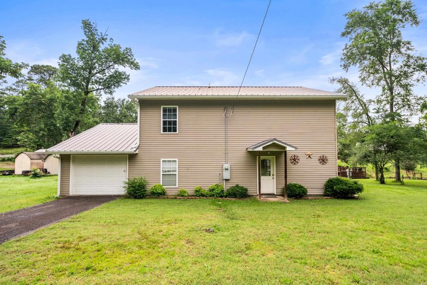 Lake House Living!! This charming 4-bedroom, 2.5-bath lake house offers the perfect blend of comfort and outdoor fun! Located just minutes from the Hill Wheatley boat launch, it’s easy to spend the day cruising Lake Hamilton and then pull your boat right up to the seawall for a lakeside lunch at home.The spacious layout includes multiple outdoor living areas—an upper and lower covered porch plus a large open deck—ideal for soaking up the sun or relaxing in the shade. Whether you're lounging by the water or entertaining friends, this property is a true lakeside retreat. Note: This home sits on Lot 61; Lot 60 is available for purchase separately.