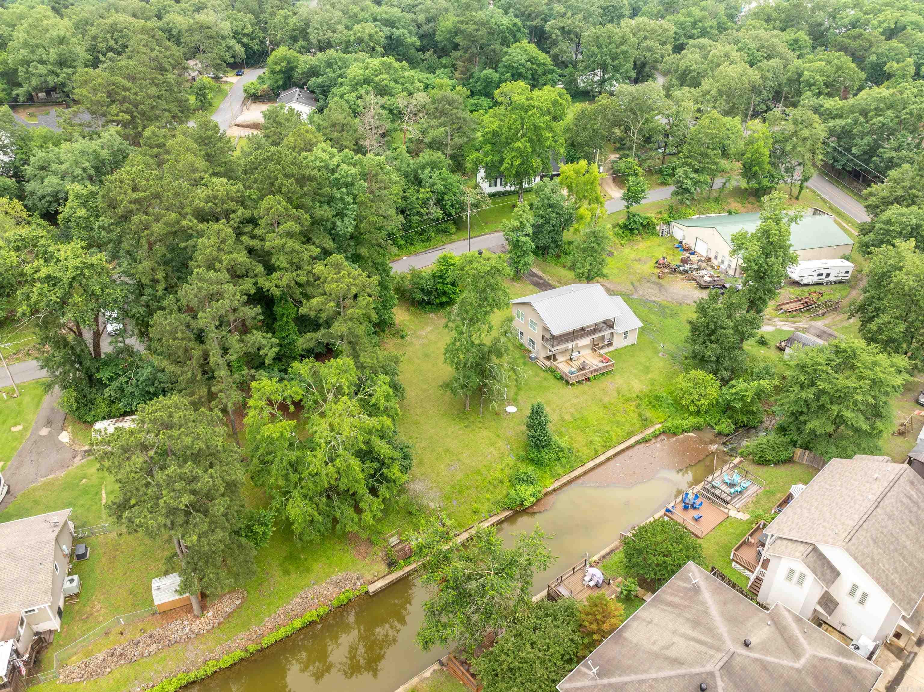 EXTRA LOT NOW INCLUDED AT SAME PRICE! 150FT OF LAKE FRONT ON ALMOST HALF AN ACRE!! Lake House Living!! This charming 4-bedroom, 2.5-bath lake house offers the perfect blend of comfort and outdoor fun! Located just minutes from the Hill Wheatley boat launch, it’s easy to spend the day cruising Lake Hamilton and then pull your boat right up to the seawall for a lakeside lunch at home.The spacious layout includes multiple outdoor living areas—an upper and lower covered porch plus a large open deck—ideal for soaking up the sun or relaxing in the shade. Whether you're lounging by the water or entertaining friends, this property is a true lakeside retreat.