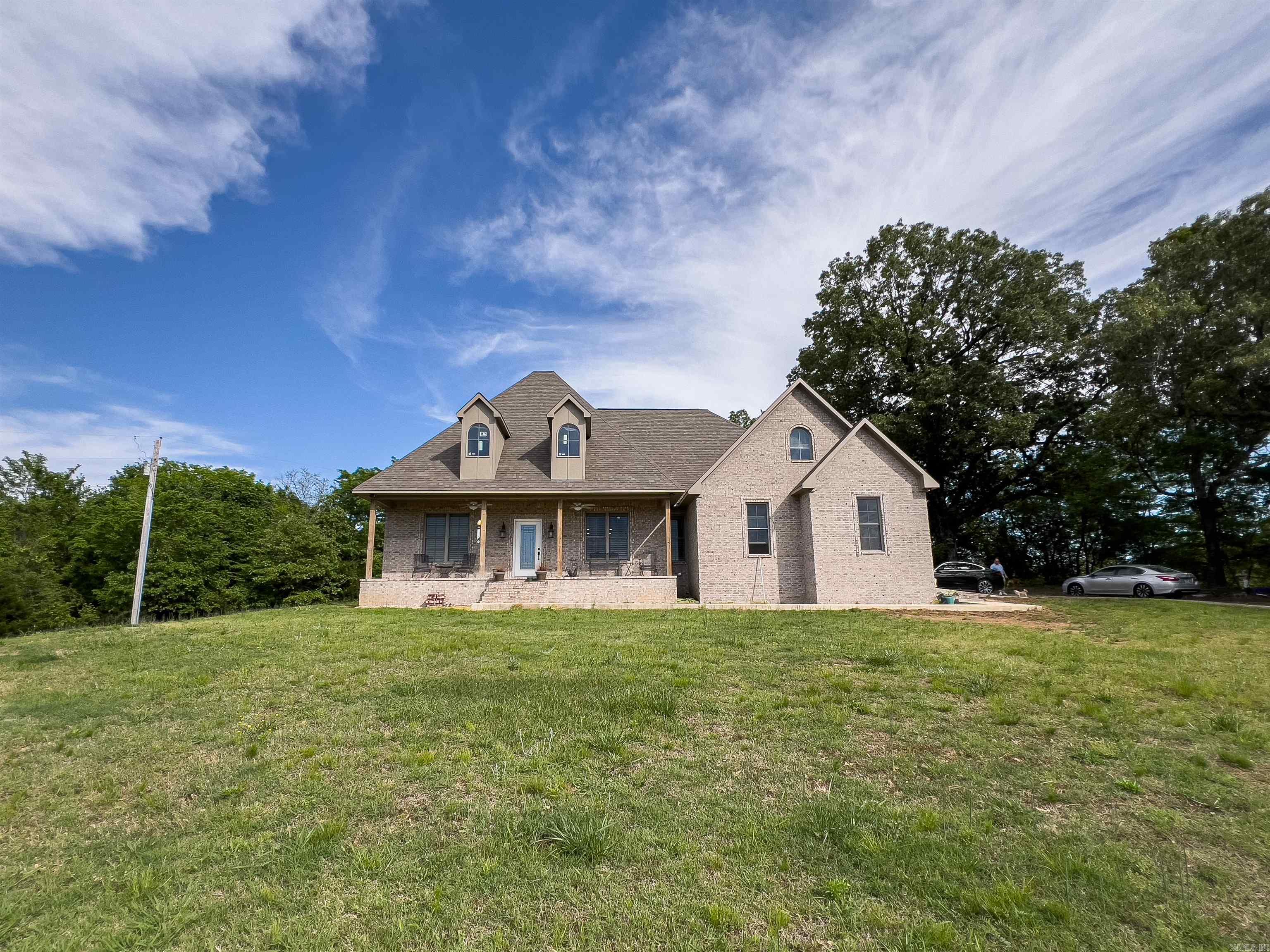 Peaceful Privacy Meets Modern Living on 5+ Acres! Welcome to this beautiful 4-bedroom, 3-bath home was built in 2022 and sits on just over 5 private acres, tucked away from the main road for ultimate seclusion and peace of mind. With low-maintenance features and stylish finishes throughout, this home offers the perfect blend of comfort and convenience. Step inside to an open-concept layout that feels fresh and inviting, featuring a well-appointed kitchen and a spacious living areaāperfect for gatherings or quiet nights in. The oversized primary suite is a true getaway, complete with a large walk-in closet, a luxurious tiled shower, double vanity, and a private water closet. The split floor plan offers two guest bedrooms and a full bath on one side of the home, giving everyone their own space. Upstairs, youāll find a flexible 4th bedroom or bonus room with its own full bath and dedicated mini-split unitāideal for guests, or flex space. Outside, enjoy the scenic setting and beautiful exterior style that gives the home its modern charm. A large metal shop with electricity and an overhead door provides fantastic space for storage, hobbies, or a workspace! Close to Wynne! Schedule today
