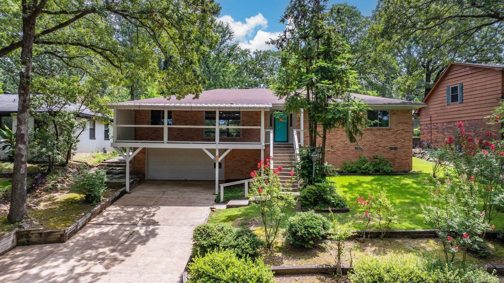Sit back, relax, and enjoy the Lakewood Lake #3 views from this mid-century modern home in Park Hill! The sunset views are at their best from the private, front balcony! This updated 1-level home features 3 bedrooms, 3 baths, original hardwood floors, open concept living, large picture window overlooking the lake, updated kitchen and a bonus sunroom. Built in 1952, this light-filled home features some of the original mid-century charm throughout. Step outside to enjoy the patio surrounded by breeze blocks. The 2-car garage also includes extra storage areas. Walk out your front door to the walking paths around the lake. Enjoy lake life with kayaking & fishing. Close by are the tennis, pickleball & basketball courts. Volunteer POA fees. Come see what lake life is all about!