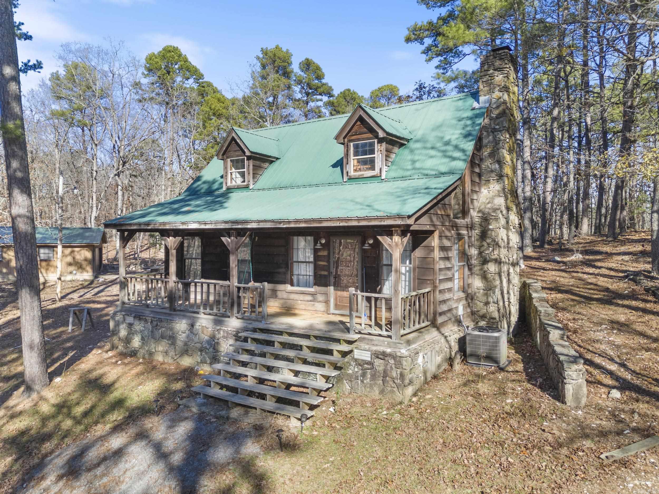 This beautifully remodeled two-story cabin on 9.83 fully fenced acres near Lake Norrell offers stunning natural beauty with rolling hills, flat grassland, and exposed quartz ridges. The property includes a second build site, a deer stand, and healthy population of deer and turkey. Inside, you'll find a cozy living area with a functional wood-burning fireplace, new ceiling fans, chandeliers, and updated fixtures. The remodeled kitchen features new appliances, custom shelving, and stylish wallpaper. The updated bathroom includes new flooring and a walk-in shower. The main bedroom has a queen bed with a new mattress, while the upstairs bedroom offers two antique twin beds. Outdoor highlights include a welcoming porch with new fans and sconces, a fully updated detached garage, and secure hog wire and barbed wire fencing. The property also boasts a 2020 HVAC system, updated plumbing and electrical, and a septic system inspected in 2020. For those interested, the home can be sold fully furnished, including club chairs, a couch, dining table, beds, and more, making this a turnkey VRBO or vacation home. Schedule your showing today before it's gone!