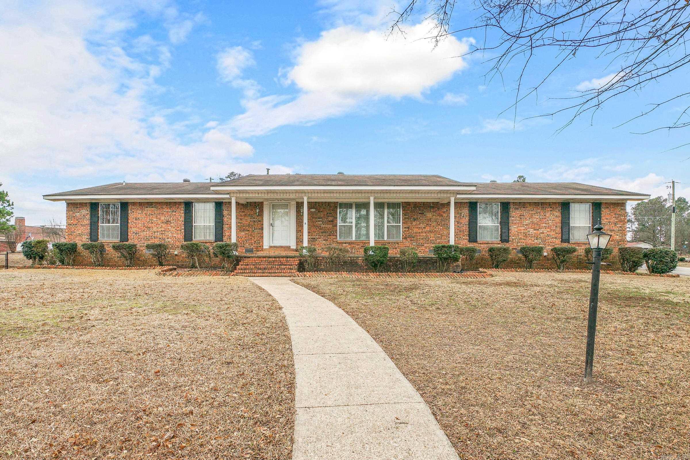 Spacious 3BR, 2BA Brick home located on a corner lot with a double carport and two large storage rooms. Inside home you find multiple living areas, including a formal living room, a separate living room, and a large den of approximately 500sq with abundant windows and direct access to the backyard. A double-sided brick gas fireplace adds warmth to both the living room and den. The kitchen offers plentiful cabinets, generous counter space, and a breakfast bar. A large utility room with counter, sink, and extra storage provides added convenience. Recent updates include two central heat & air units (2018), water heater (2021) and roof (2015). Outdoors, a chain-link fenced area in the backyard for great for entertaining or gardening.