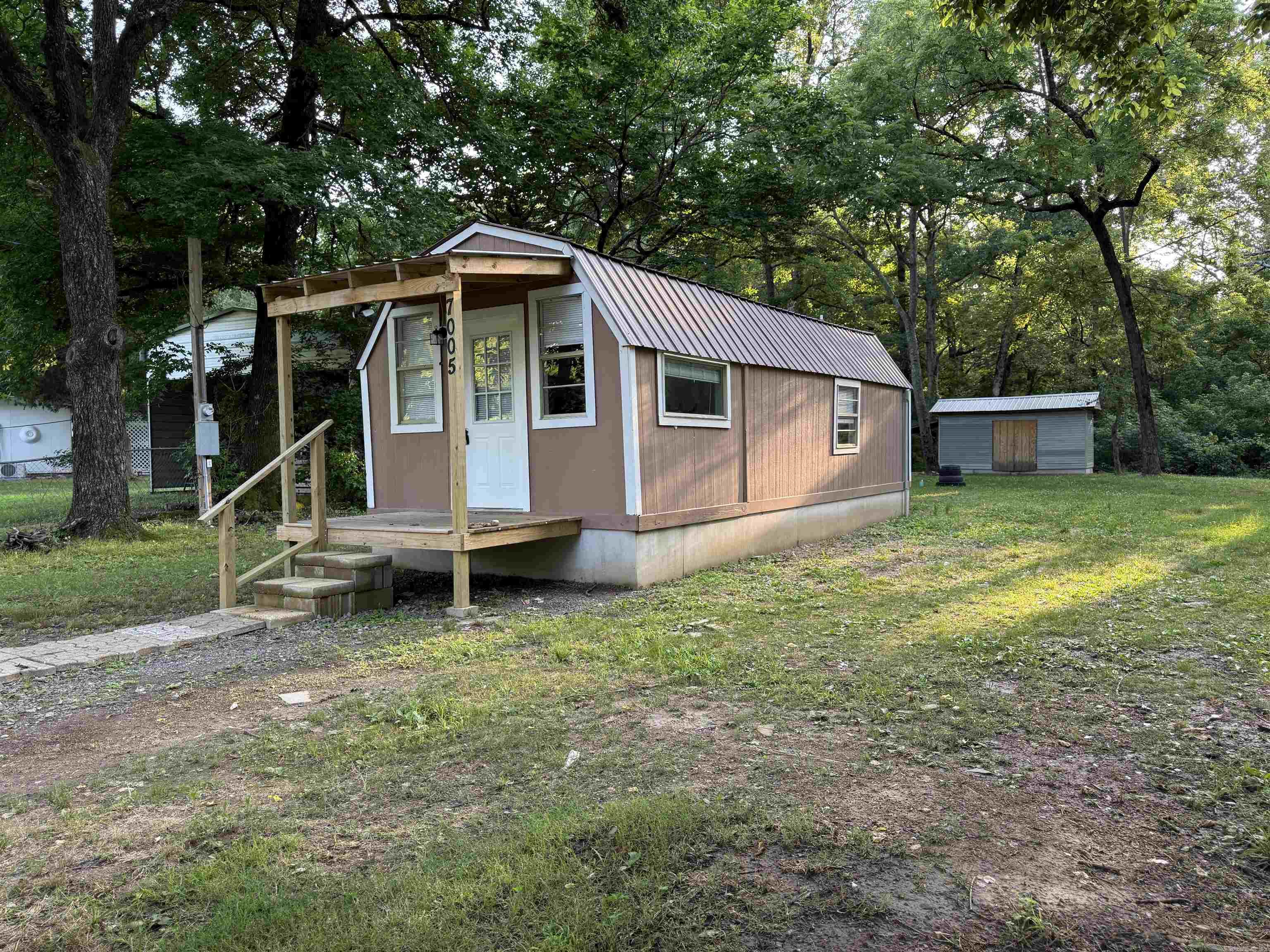 Jessieville School District! Cute 1 room tiny furnished house with full kitchen and full bath on a nice grassy 1/2 acre of land. Own & Live affordably! Or Buy to Rent out!