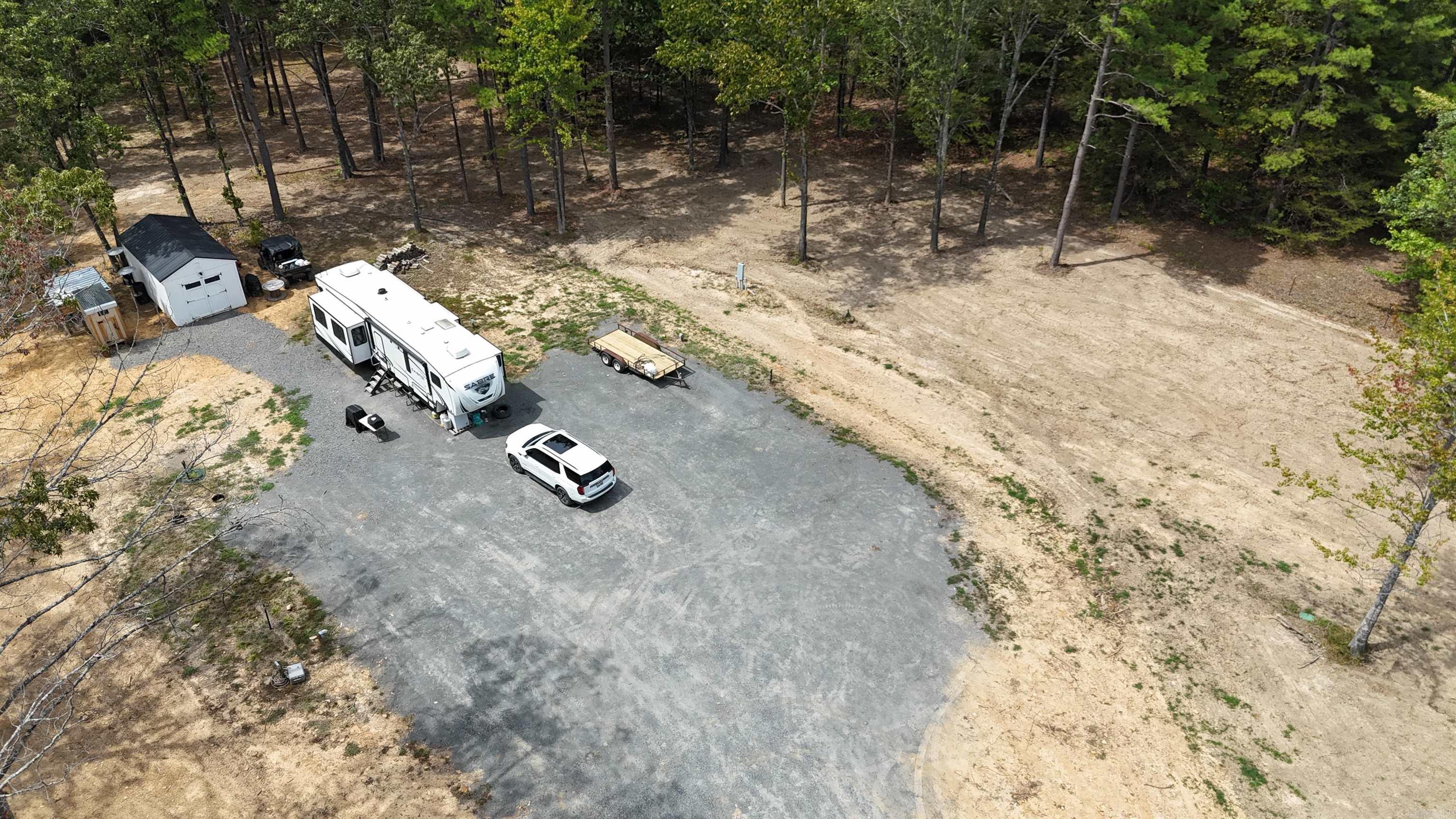 Looking for an affordable location near the waters of Greers Ferry lake or the hunting grounds of the Public Wildlife Management lands? Here is just over 3 acres, fenced on one side, nicely cleared, nice driveway and pad for 3 camper slots! Power meter, fiber, septic, water all on 1 meter, supporting all 3 units. All 3 units have full access to these utilities however the 1 meter helps keep connections a breeze! As you and your family and friends come & go you will not have to constantly update the utilities each time. Site is currently being used by owners, call today to schedule your personal tour of the property! Site has 2 parcels 3.12 & .08. total 3.20 per tax card.