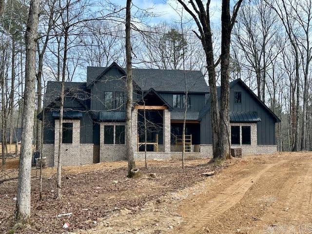Welcome to this beautiful new construction home in Hazel Oak of Benton! You will appreciate the acreage lot and everything this spacious home has to offer. This top tier builder has thought of everything for this home, with features that include: wood floors and stairs, wooden beams, vaulted ceiling, tongue and groove work, pre-wiring for surround sound and alarm system, custom accent walls, and spray foam insulation. The kitchen is a chef's dream with double ovens, ice-maker, custom cabinetry, pantry, and a large island. The special touches extend to the outside as well, with a large covered patio featuring a fireplace, irrigation system, and an extended driveway for plenty of parking. This 5-bedroom (the 5th could also be an office/flex space), 3.5-bathroom home has everything needed for family entertaining.