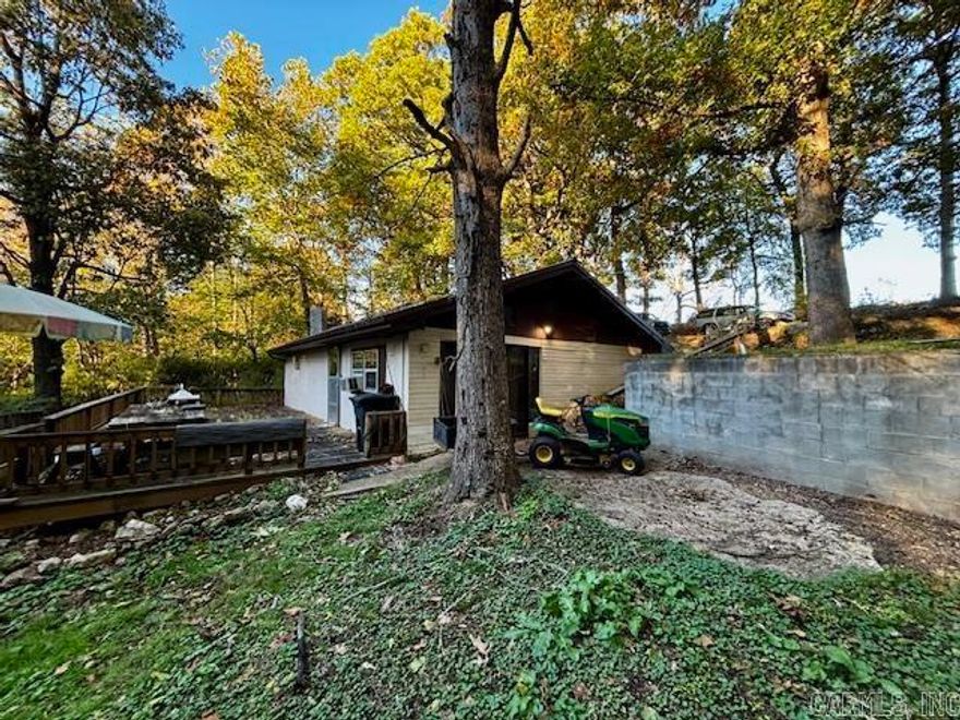 Tucked into the hillside and surrounded by peace and quiet, this super energy-efficient home offers charm, warmth, and scenic wooded views. Inside, the open floor plan features a vaulted living room ceiling with exposed wood beams and a cozy gas stove set on a rock hearth. The kitchen opens to the dining area and includes a breakfast bar, generous counter space, and brand-new appliances (2024). The remodeled bathroom features a walk-in shower. Step outside to enjoy the 16x40 deck overlooking the tranquil acreage. Property includes a 20x20 wired shop and a metal roof that’s only 6 years old. A retreat that’s practical, comfortable, and full of character.