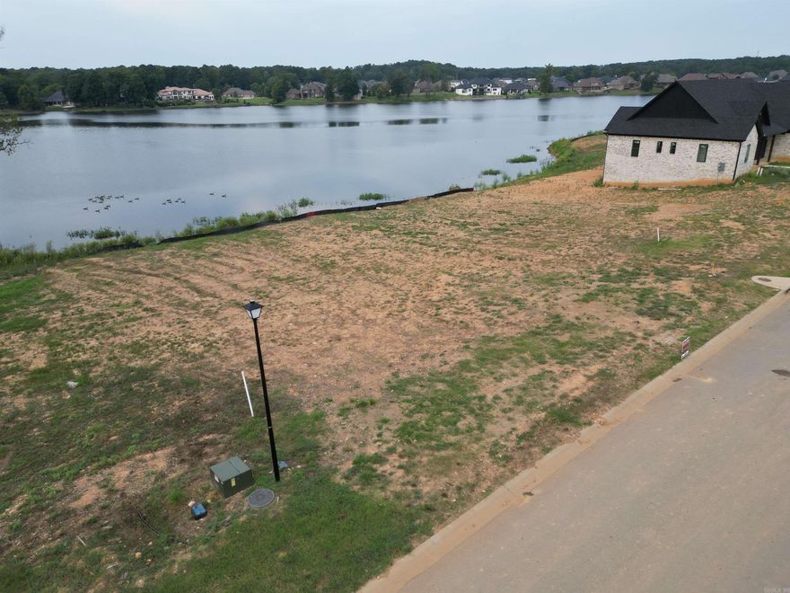 Build your dream home on this stunning lakefront lot in the highly sought-after Hurricane Lake Estates! This .34-acre cleared lot offers unobstructed, views of the water and is ready for your custom home. Whether you're planning a one-story (minimum 2,500 sq. ft.) or two-story (minimum 2,800 sq. ft.) home, this property provides an ideal canvas for lakeside living. Utilities are available, and buyers are encouraged to confirm building requirements with their builder. Community amenities include sparkling community pool splash pads for children new park at the entrance of Phase 1, tennis & pickleball courts lake access for boating and fishing. Year-round community events and activities. Located just 15 minutes from Hurricane Golf & Country Club, shopping centers, and grocery stores. This location combines luxury, convenience, and lifestyle. Don’t miss your chance to own a prime lakefront lot in one of the most desirable neighborhoods in the area. Bring your builder and start planning your forever home today!  VACANT LOT NO SPD