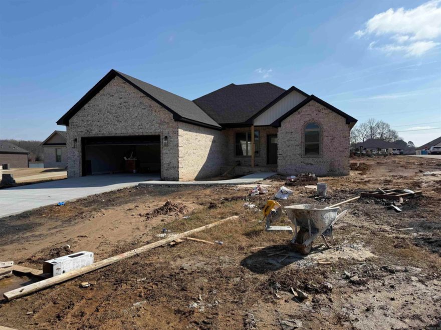 Super nice all brick house on big lot with oversize garage .Open airy floor plan with dining area and big bar pantry beautiful granite countertops and custom wall fireplace with heat with custom flame design .Beautiful split bedroom design with private m/br and bath area large soaking tub 2 walk-in closets separate vanity for his and hers .STAINLESS steel appliances and beautiful backsplash and light fixtures.This house is move getting close still time to pick flooring colors .