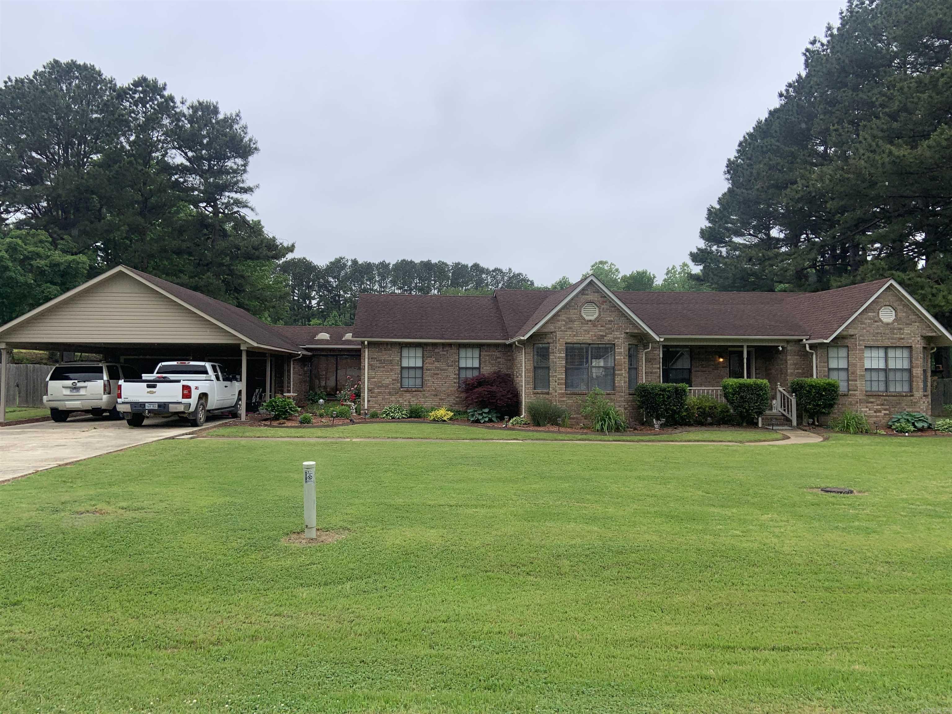 Beautiful large house with with 3 living areas. LR, Dining & Kitchen Combo, all remodeled w/all tile flooring in 2013. Kit. w/ breakfast bar and Island w/sink. LR w/Fireplace insert & Vaulted ceiling. Large Family Room w/ gas log FP that opens onto pool area, bath w/walk-in shower that can be accessed from pool area. Large Den w/stained concrete floor. Vaulted office w/tile flooring. 13 X 26 ft screened in patio overlooking the 20 X 40 ft. in-ground concrete pool. Two Separate outside bldgs plus a metal awning for storage. Wood privacy fencing on two sides of yard. Gazebo in front yard. See Agent Remarks