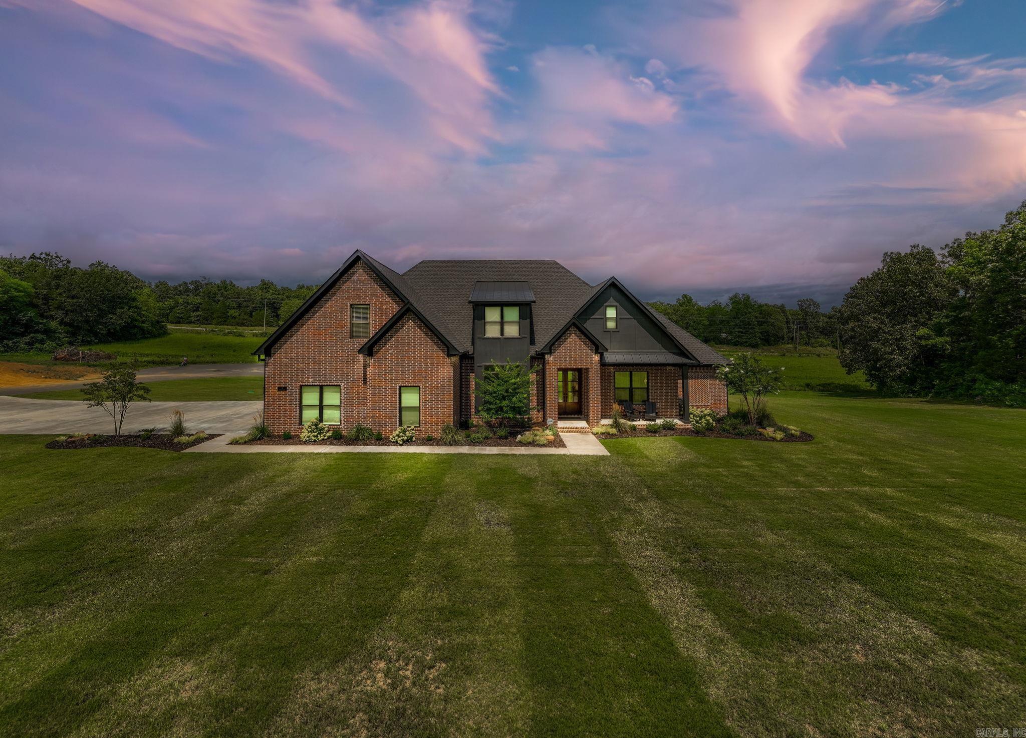 Step into this stunning 2023 custom-built home located in the prestigious Highland Hills Subdivision. Sitting on a 1.18-acre lot, this 3,408 sq. ft. home combines high-end finishes, functional design, and generous outdoor space - all just minutes from Conway. The kitchen boasts a double oven, 2 dishwashers, a double refrigerator and a massive honed granite kitchen island - perfect for hosting. The spacious primary suite features a spa-style bathroom, oversized custom shower, and massive walk-in closet. The 2 other downstairs bedrooms are well-sized and include walk-in closets. The second story includes a 4th bedroom, full bathroom, and a bonus room - ideal for an office, playroom, or media room. High ceilings, custom built-ins, and luxury finishes are featured throughout. The oversized 3 car garage includes a storm shelter, ample storage, and generator-ready panel hookup. Included outdoors is a covered back patio with gas fireplace and black steel fenced backyard. All of this and more in a quiet, upscale neighborhood with wide lots and a peaceful setting.