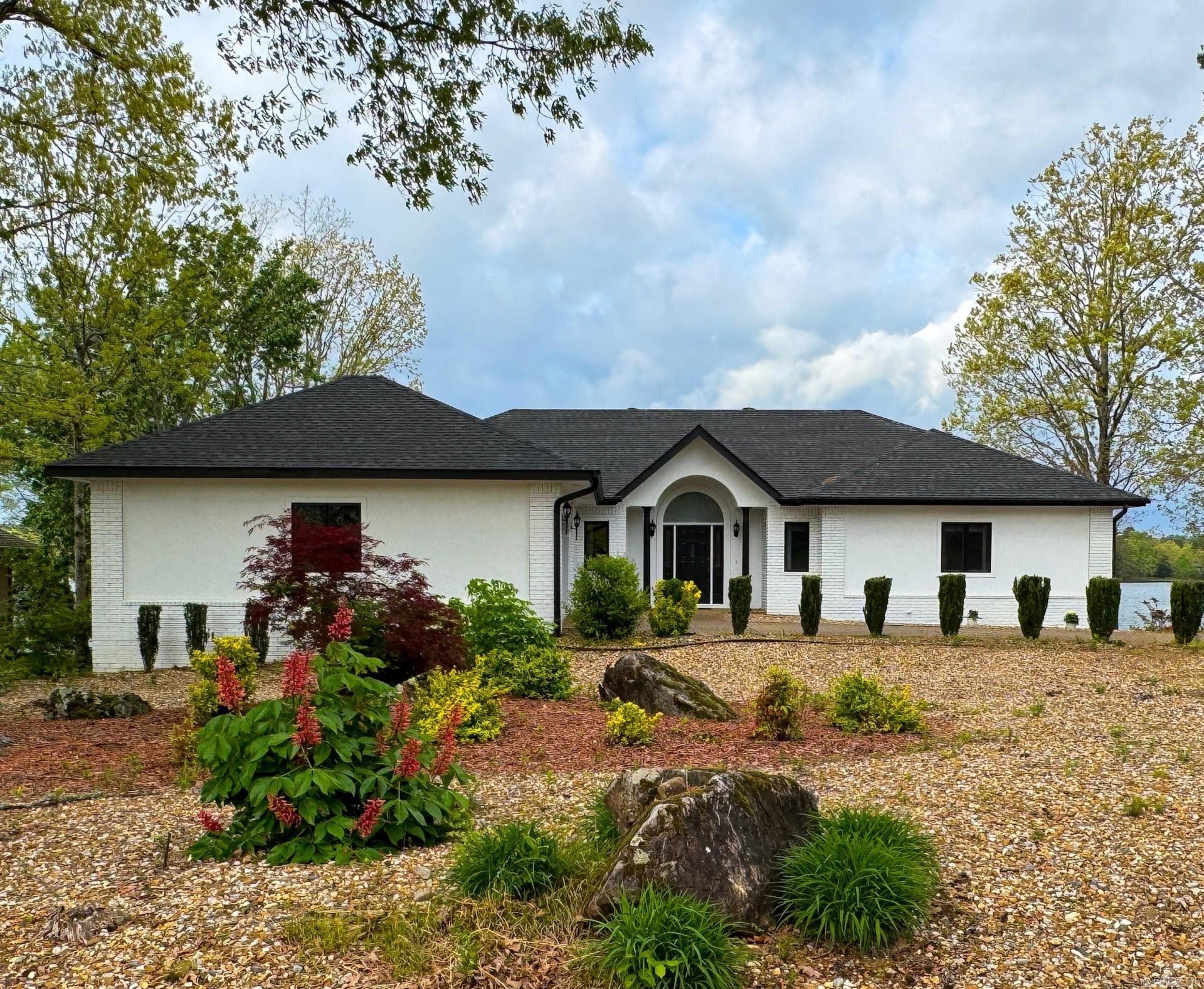 Nestled on a tranquil peninsula with unparalleled panoramic views of Lake Balboa, this beautiful lakefront home is a rare gem in Hot Springs Villageās most sought-after location. This meticulously maintained residence offers the ultimate in lakeside living. Step through the door to discover gleaming hardwood floors, vaulted ceilings, and an expansive great room bathed in natural light from a wall of windows. The large sunroom is a haven for relaxation, showcasing breathtaking sunsets over the shimmering lake. The kitchen is designed for both function and style, boasting abundant cabinetry, generous counter space, opening to a spacious dining area perfect for entertaining family and friends. The luxurious primary suite is a private retreat, open to a secluded deck with spectacular water views. Outside, the large, impeccably landscaped lot borders lush green space, ensuring privacy and tranquility. Enjoy direct lake access with your own boat dock and lift, ideal for boating, fishing, or simply soaking in the beauty of Lake Balboa. Crowned with a new roof and meticulously maintained, this move-in-ready home is the epitome of lakefront elegance!
