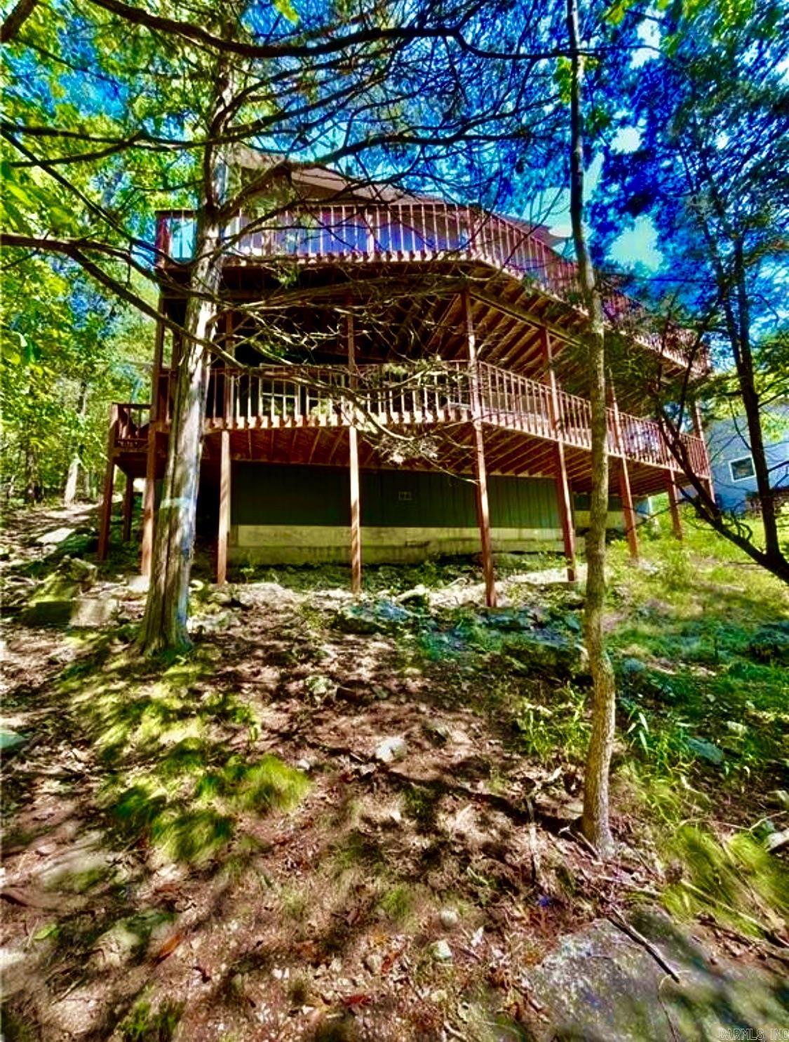 Dream of living where the Mountains touch the water, & the Eagles are seen in the skies? This is literally living in Paradise! Lost Bridge Village on Beaver Lake is one of Arkansas's Gems!! You have 28,000 acres of some of the most beautiful Lake water surrounding your home! Not to mention breath taking bluffs to see some of the most beautiful sunsets! This area is so gorgeous! The bonus of it all, the Village has a private Airport to fly your private fleet in & out, right outside door step! This home is on the edge of the water, & is large enough to be a family compound, or a VRBO (which it is currently). This home has two Living areas both with Fireplaces! A beautiful bridge balcony on the second floor, & cathedral ceilings with an open floor plan! First floor: Master Suite/2.5 BA Second floor:2 BDS/1BA Third Floor: 2BDS/1BA Living room with FP & Game RM! Porches with Lake Views on all levels! You can hear the water crashing against the banks! This is truly a piece of tranquility & the best life waiting for you! This property has been used as AIRBNB for 5 months out of the year, that is booked solid yearly! Come make this your paradise! You will fall in LOVE!