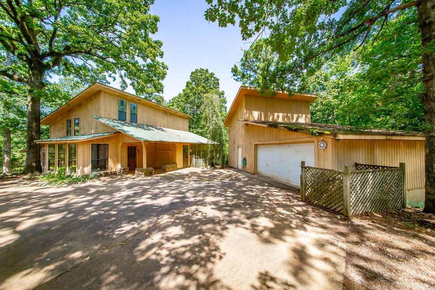 This unique, custom-built home offers the perfect blend of privacy, charm, and function—just 3 miles from the Point Cedar boat ramp on Lake DeGray. With 2,225 sq ft of living space, the home features 2 bedrooms, 2.5 bathrooms, a large pantry, and a one-of-a-kind layout designed for comfort and flexibility. A cozy wood-burning stove adds warmth and character, while the sunroom and wraparound screened-in porch provide the perfect spaces to relax and take in the natural beauty around you.  Situated on 6.5 acres with a fenced backyard, the property also includes a separate home site with septic already installed—ideal for a guest house, future build, or investment opportunity. A spacious 22x35 garage/workshop offers room for projects, storage, or lake gear.  Bonus: the sellers are including matching LVP flooring for the upstairs, ready for new owners to install.  Don’t miss your chance to own this one-of-a-kind property near the water, with room to roam and room to grow!