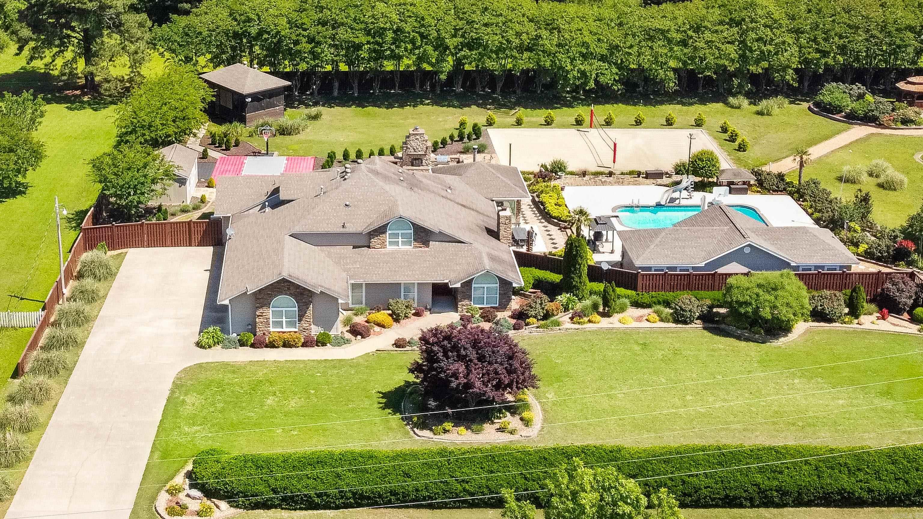 This incredible estate is the ultimate retreat, offering over 4,700 sq ft of thoughtfully designed space and endless entertainmentāall in a prime location just 10 minutes from both downtown Benton and Bryant. With three bedrooms (and potential for a fourth), three full baths, and two half baths, the layout includes an office, massive game room, and a stunning sunroom with its own fireplaceāall overlooking the backyard oasis. Originally taken down to the studs and completely remodeled in 2008, the home has seen numerous updates since. The remodeled kitchen features a large, curved breakfast bar opening to a spacious family room, while the grand entry boasts soaring ceilings and a cozy wood-burning fireplace. Outside, enjoy resort-style amenities, including a saltwater pool, pool house with kitchenette and half bath, basketball sports court, sand volleyball court, and a private enclosed hot tub or golf simulator area. A storage building with electricity. Every detail has been carefully considered to create a home that blends luxury, comfort, and entertainment. Come experience it for yourself!